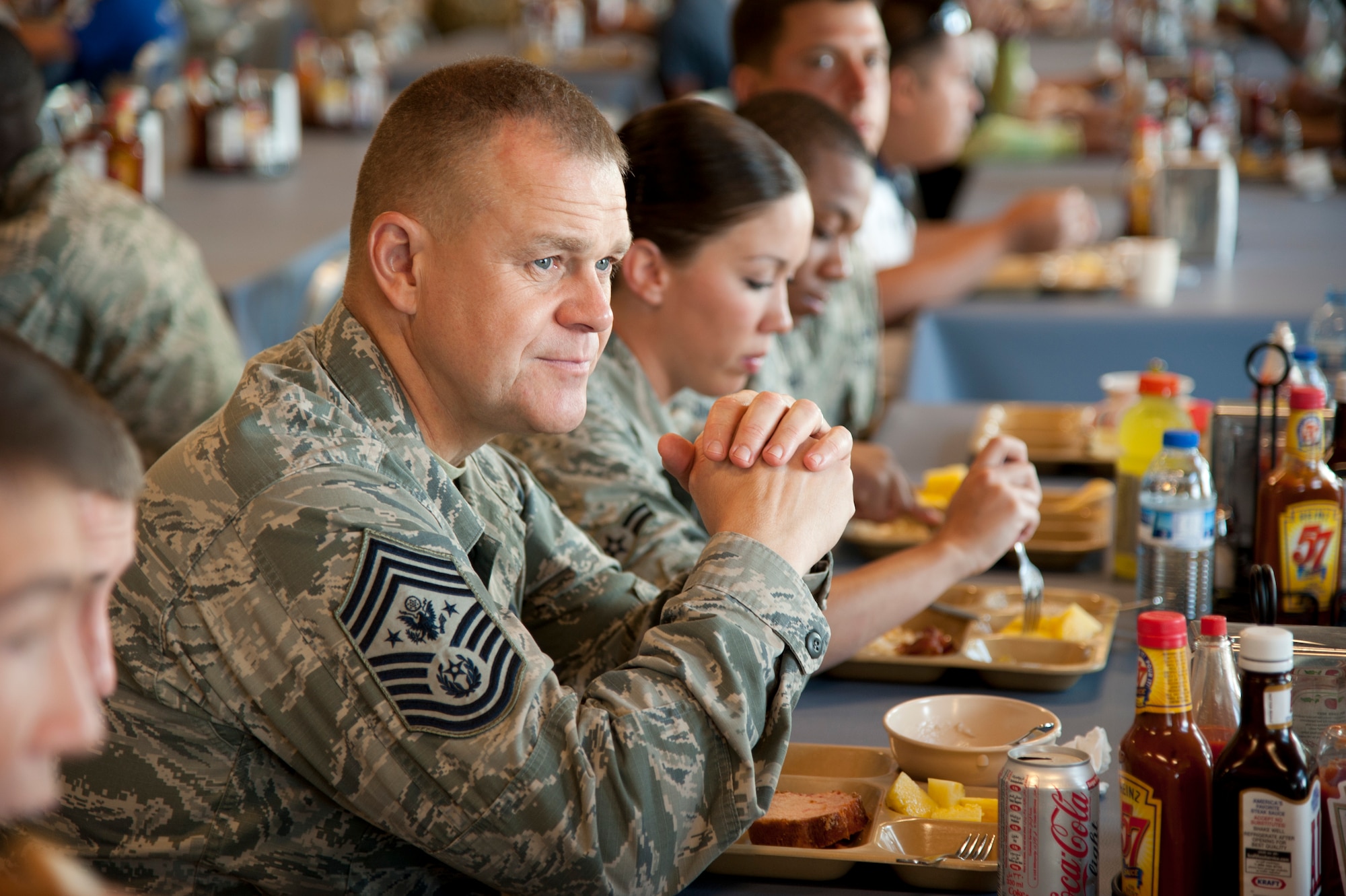 Chief Master Sgt. of the Air Force James A. Roy visits with a group of Air Force junior enlisted Airmen deployed to Camp Lemonnier, Combined Joint Task Force – Horn of Africa and other tenant commands over breakfast at the new Camp Lemonnier galley here May 6. Roy visited with the Airmen to address their concerns and share information regarding the Air Force directly from a senior enlisted leadership perspective. (U.S. Air Force photo by Senior Airman Lael Huss)