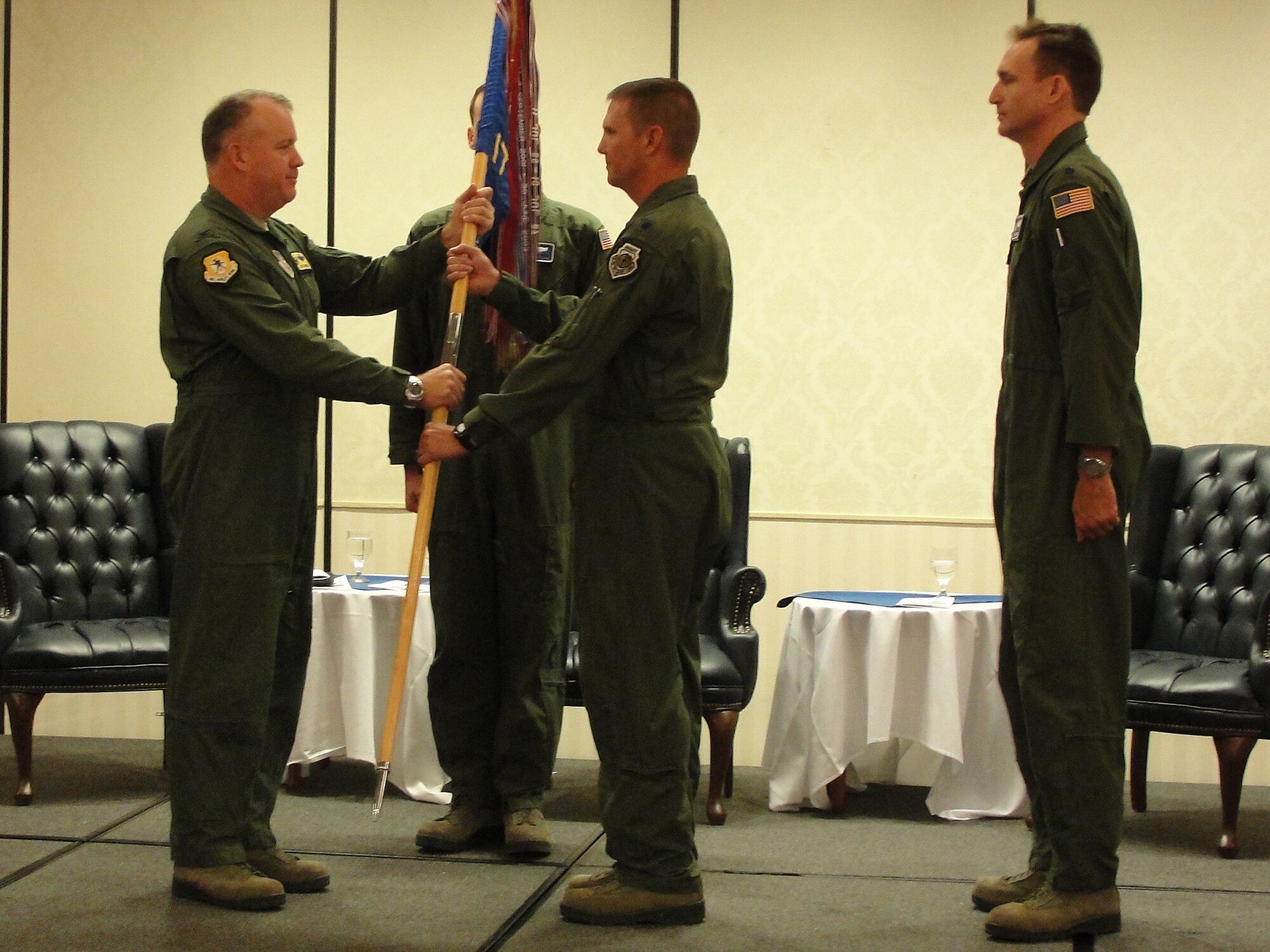 Col. Erik Hansen passes the 17th Airlift Squadron guidon to Lt. Col. Todd
Groomes while Master Sgt. Christopher Copans (center) and Lt. Col. Michael Madsen observe the ceremony during the 17th AS change of command at Joint Base Charleston - Air Base, May 4. Hansen is the 437th Airlift Wing commander, Groomes is the new 17th AS commander, Copans is the 17th AS superintendent and Madsen is the former 17th AS commander. (U.S. Air Force photo/1st Lt. Daniel Klepper)

