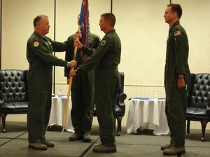 Col. Erik Hansen passes the 17th Airlift Squadron guidon to Lt. Col. Todd
Groomes while Master Sgt. Christopher Copans (center) and Lt. Col. Michael Madsen observe the ceremony during the 17th AS change of command at Joint Base Charleston - Air Base, May 4. Hansen is the 437th Airlift Wing commander, Groomes is the new 17th AS commander, Copans is the 17th AS superintendent and Madsen is the former 17th AS commander. (U.S. Air Force photo/1st Lt. Daniel Klepper)
