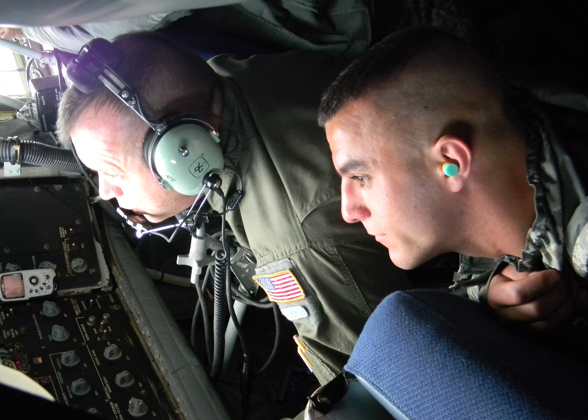 PEASE AIR NATIONAL GUARD BASE, N.H. -- Master Sgt. Al Beaulieu refuels a KC-135 while Airman 1st class Don Boyer observes May 5. Five wing members with three of their  family members, experienced the mid-air refueling during the flight. (National Guard photo by Capt. Suzanne Lamb/RELEASED)