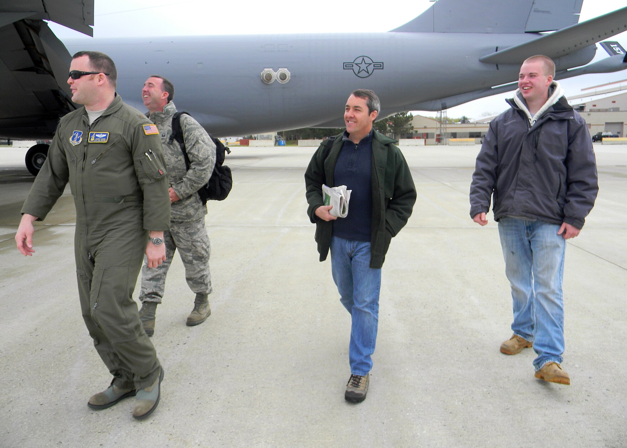 PEASE AIR NATIONAL GUARD BASE, N.H. -- Maj. Corey Aiken, Master Sgt. Al Poulin, Graeme Lamb, and Christopher Poulin prepare to board a KC-135 for an orientation flight here May 5. Five wing members with three of their  family members, experienced the mid-air refueling during the flight. (National Guard photo by Capt. Suzanne Lamb/RELEASED)