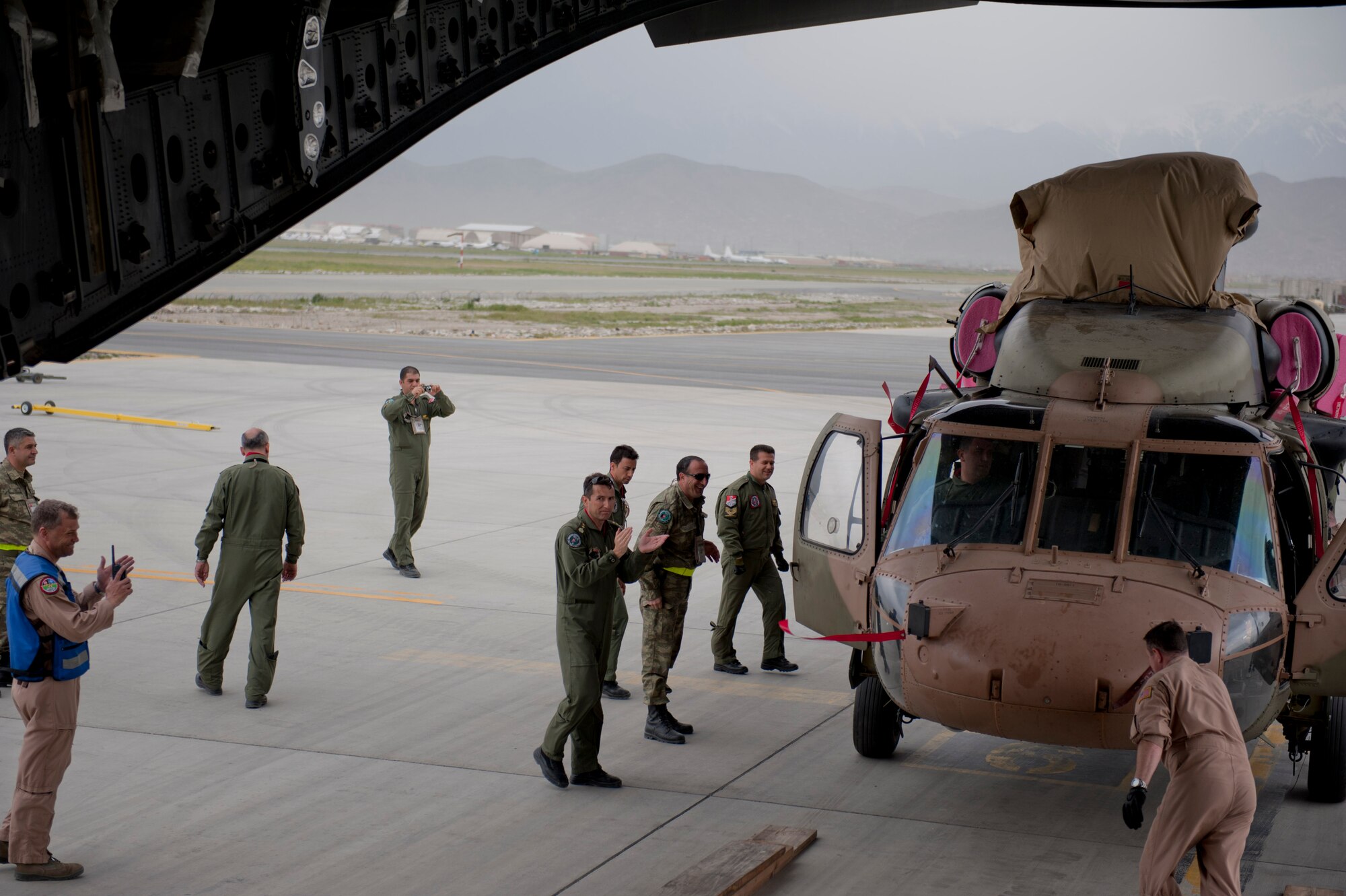 Turkish air force members clap for the U.S. Air Force C-17 Globemaster III aircrew after offloading a TURAF UH-60 Black Hawk helicopter from the C-17 May 5, 2012, at Kabul International Airport, Afghanistan. The C-17 aircrew from Joint Base McGuire-Dix-Lakehurst, N.J., transported the helicopter to Kabul from Incirlik Air Base, Turkey. The joint support mission provided smooth delivery of the helicopter to replace one that crashed December 2011. (U.S. Air Force photo by Senior Airman Anthony Sanchelli/Released)