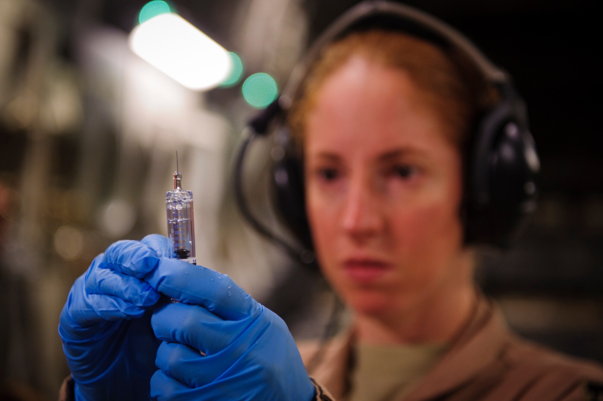 SOUTHWEST ASIA – Capt. Jennifer Williams, 379th Expeditionary Aeromedical Evacuation Squadron nurse, measures fluid for an injection for a patient during an evacuation flight to Landstuhl Regional Medical Center, Germany, April 25, 2012. (U.S. Air Force photo/Staff Sgt. Nathanael Callon)