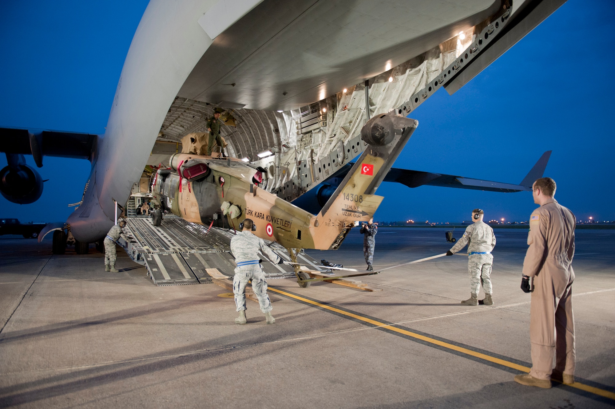 A Turkish air force UH-60 Black Hawk helicopter is loaded onto a U.S. Air Force C-17 Globemaster III May 1, 2012, at Incirlik Air Base, Turkey. A C-17 aircrew from Joint Base McGuire-Dix-Lakehurst, N.J., transported the helicopter to Kabul, Afghanistan, May 5, 2012. The joint support mission provided smooth delivery of the helicopter to replace one that crashed December 2011. (U.S. Air Force photo by Senior Airman Anthony Sanchelli/Released)