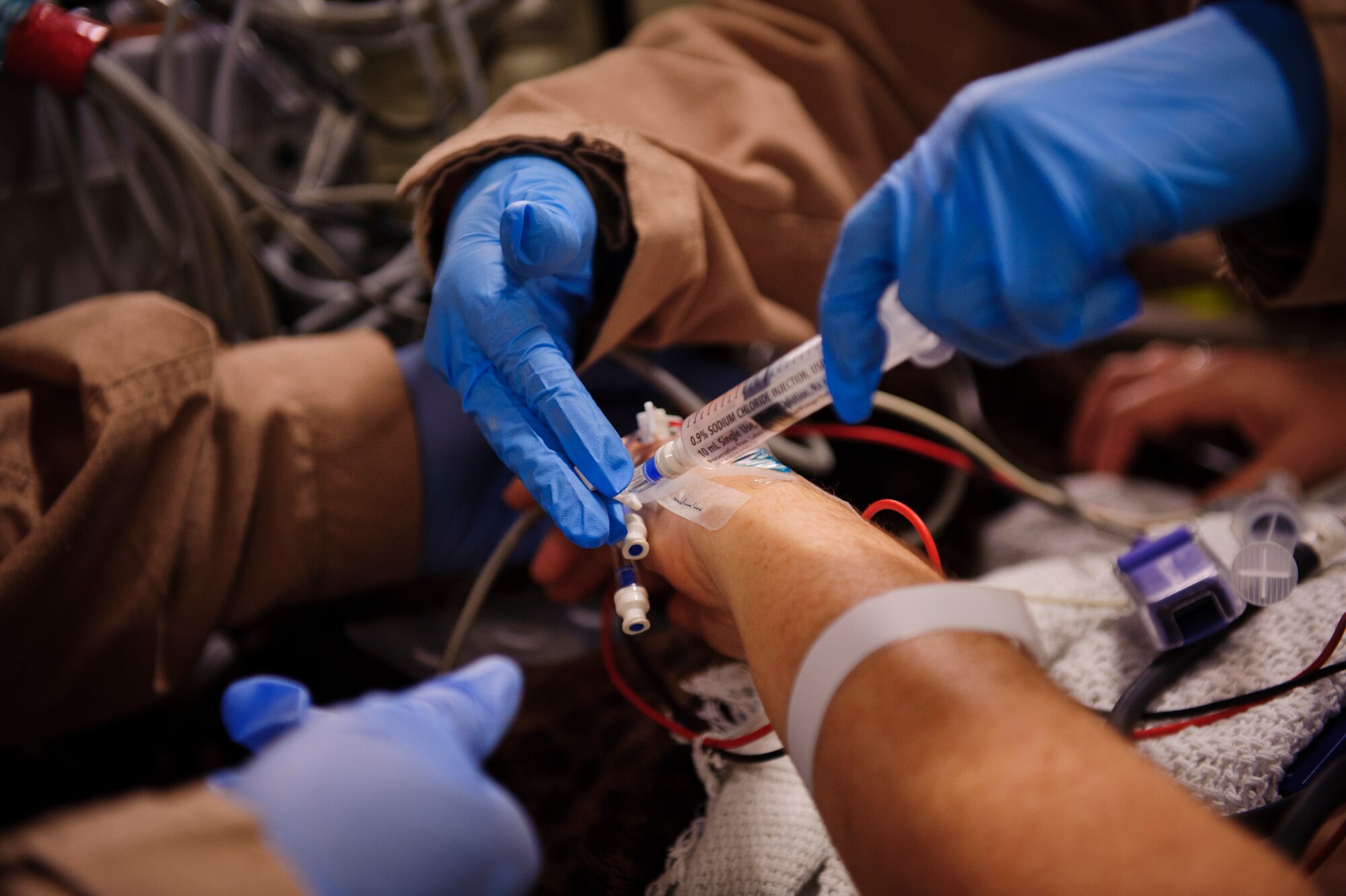 SOUTHWEST ASIA – Capt. Jennifer Williams, 379th Expeditionary Aeromedical Evacuation Squadron nurse, administers fluids into a patient’s IV line during an evacuation flight to Landstuhl Regional Medical Center, Germany, April 25, 2012. (U.S. Air Force photo/Staff Sgt. Nathanael Callon)