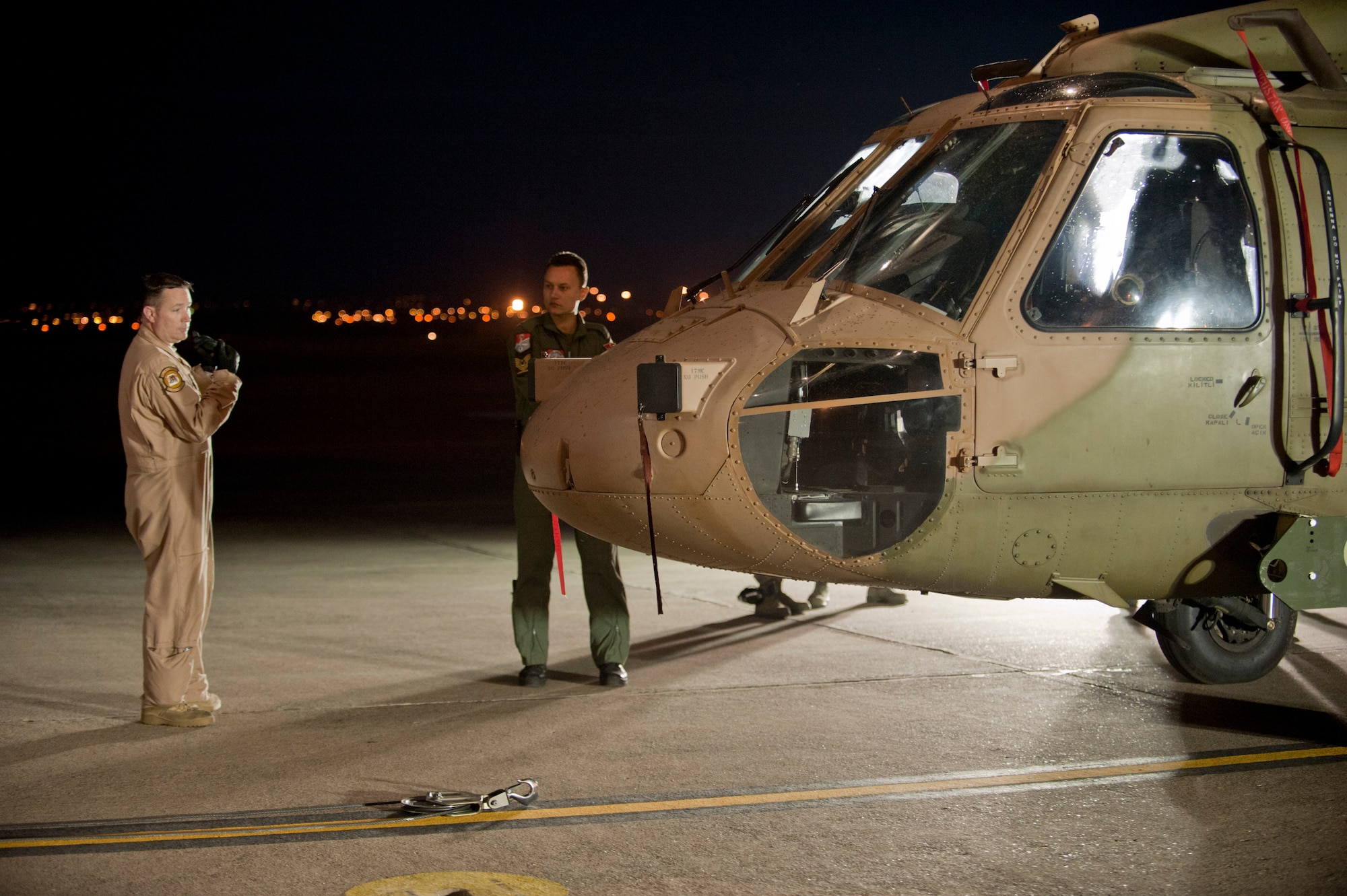 Tech. Sgt. Michael Ferguson, 6th Airlift Squadron loadmaster, left, directs Turkish air force members in moving a TURAF UH-60 Black Hawk helicopter onto a U.S. Air Force C-17 Globemaster III May 1, 2012, at Incirlik Air Base, Turkey. The C-17 aircrew from Joint Base McGuire-Dix-Lakehurst, N.J., transported the helicopter to Kabul, Afghanistan, May 5, 2012. The joint support mission provided smooth delivery of the helicopter to replace one that crashed December 2011. (U.S. Air Force photo by Senior Airman Anthony Sanchelli/Released)