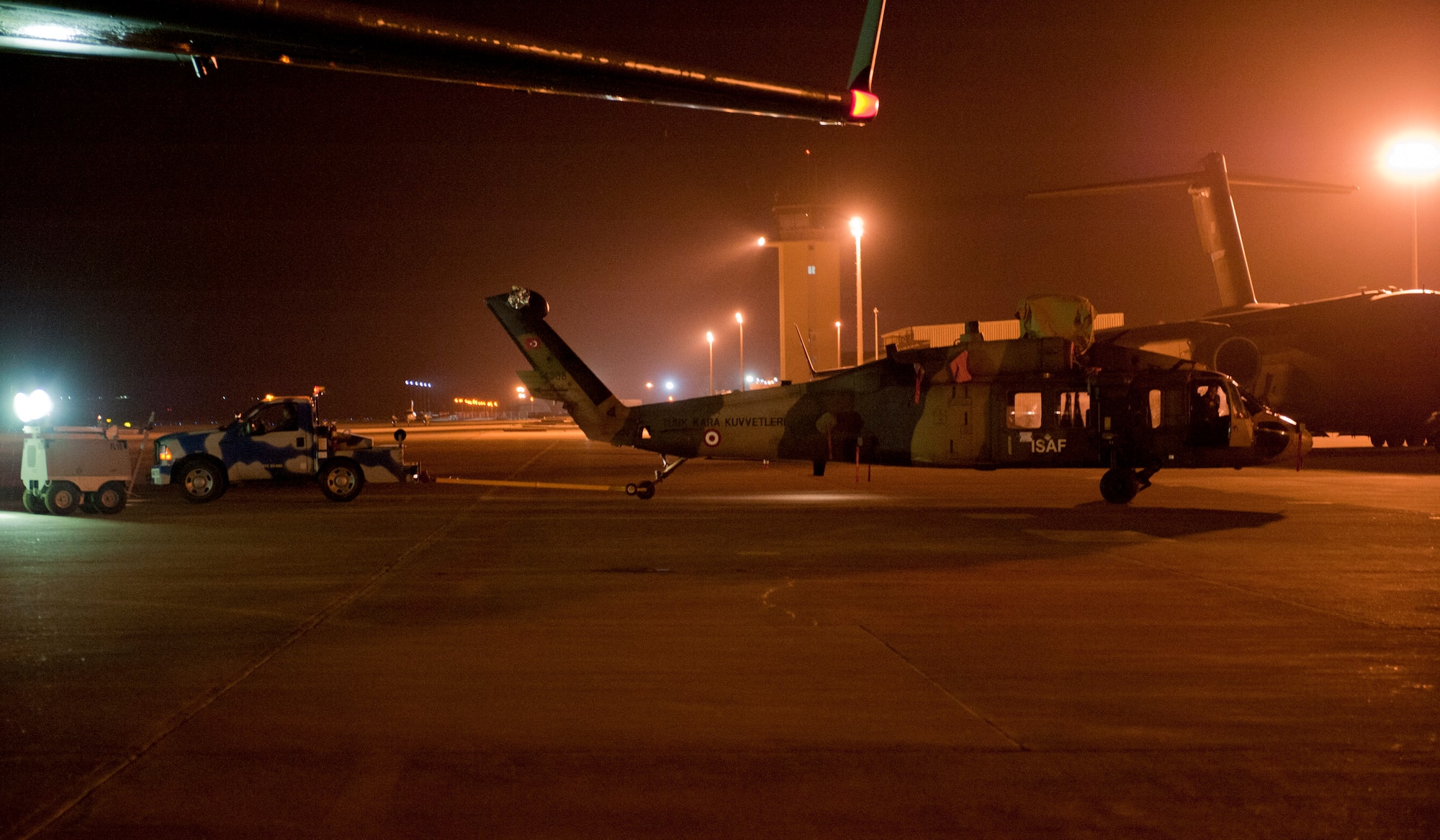 A Turkish air force UH-60 Black Hawk helicopter is transported to the flightline by a TURAF member to be loaded onto a U.S. Air Force C-17 Globemaster III May 1, 2012, at Incirlik Air Base, Turkey. A C-17 aircrew from Joint Base McGuire-Dix-Lakehurst, N.J., transported the helicopter to Kabul, Afghanistan, May 5, 2012. The joint support mission provided smooth delivery of the helicopter to replace one that crashed December 2011. (U.S. Air Force photo by Senior Airman Anthony Sanchelli/Released)