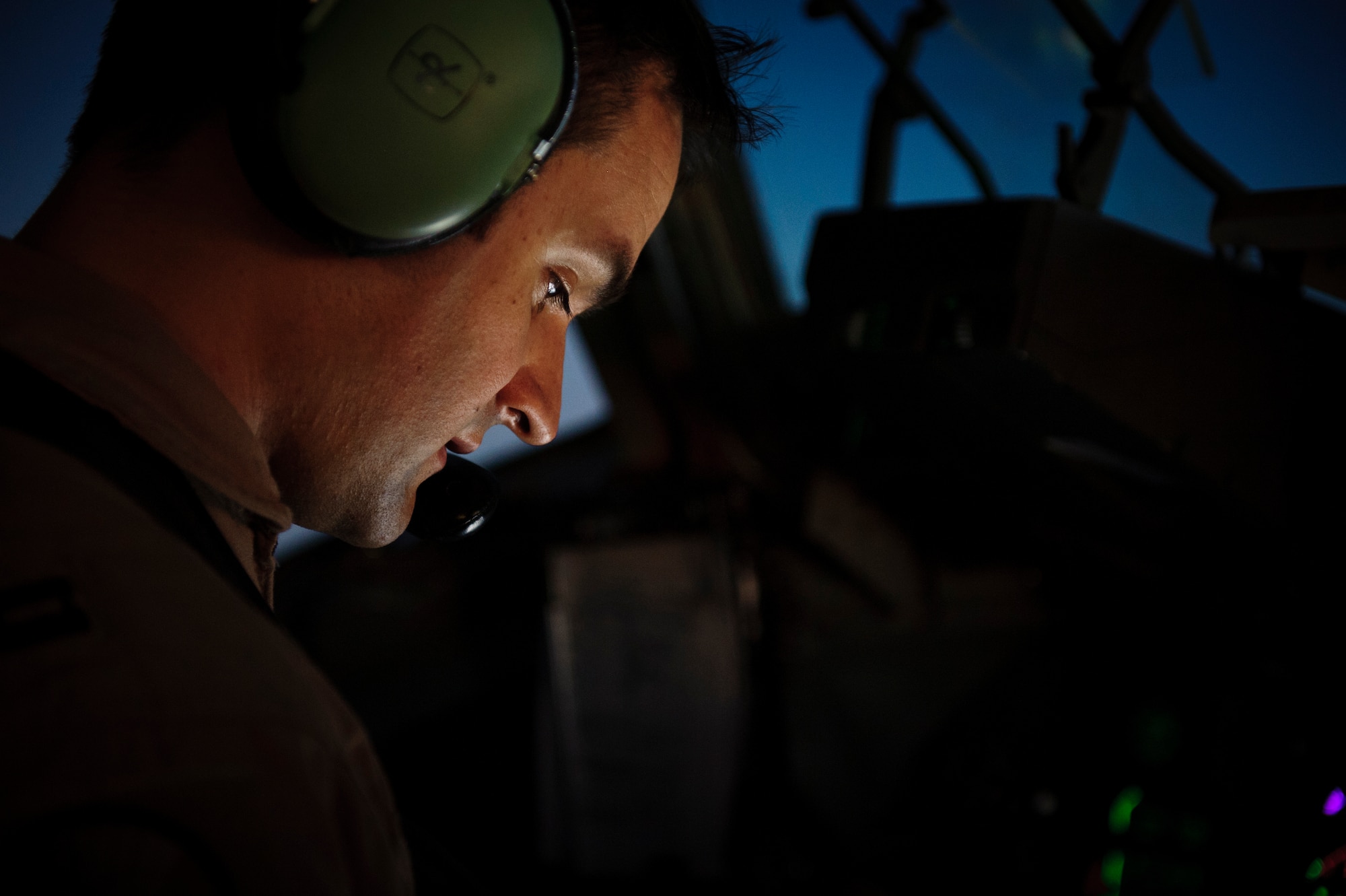 SOUTHWEST ASIA – Capt. Tyrus Scott, 816th Expeditionary Airlift Squadron pilot, checks a technical order during an evacuation flight to Landstuhl Regional Medical Center, Germany, April 25, 2012. (U.S. Air Force photo/Staff Sgt. Nathanael Callon)