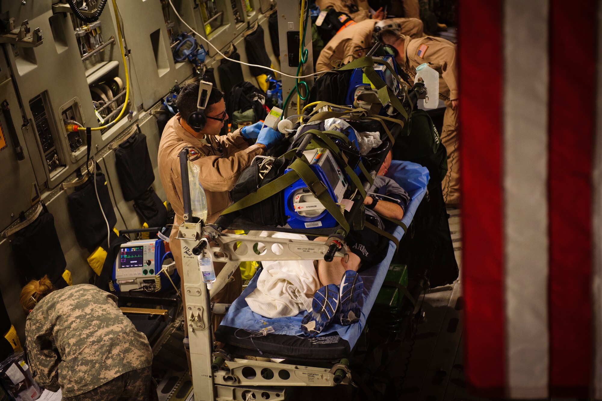 SOUTHWEST ASIA – First Lt. Eric Rodriguez, 379th Expeditionary Aeromedical Evacuation Squadron nurse, checks on a patient’s medical equipment during an evacuation flight to Landstuhl Regional Medical Center, Germany, April 25, 2012. (U.S. Air Force photo/Staff Sgt. Nathanael Callon)