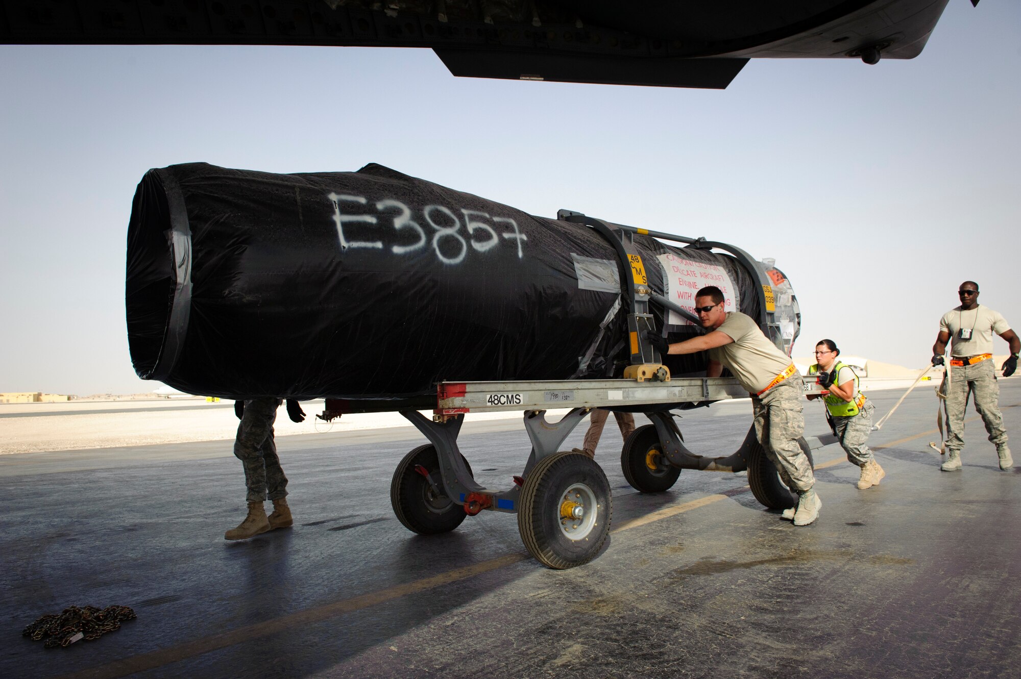 SOUTHWEST ASIA – Airmen from the 8th Expeditionary Air Mobility Squadron push an aircraft engine towards a C-17 Globemaster III for loading here April 25, 2012. (U.S. Air Force photo/Staff Sgt. Nathanael Callon)