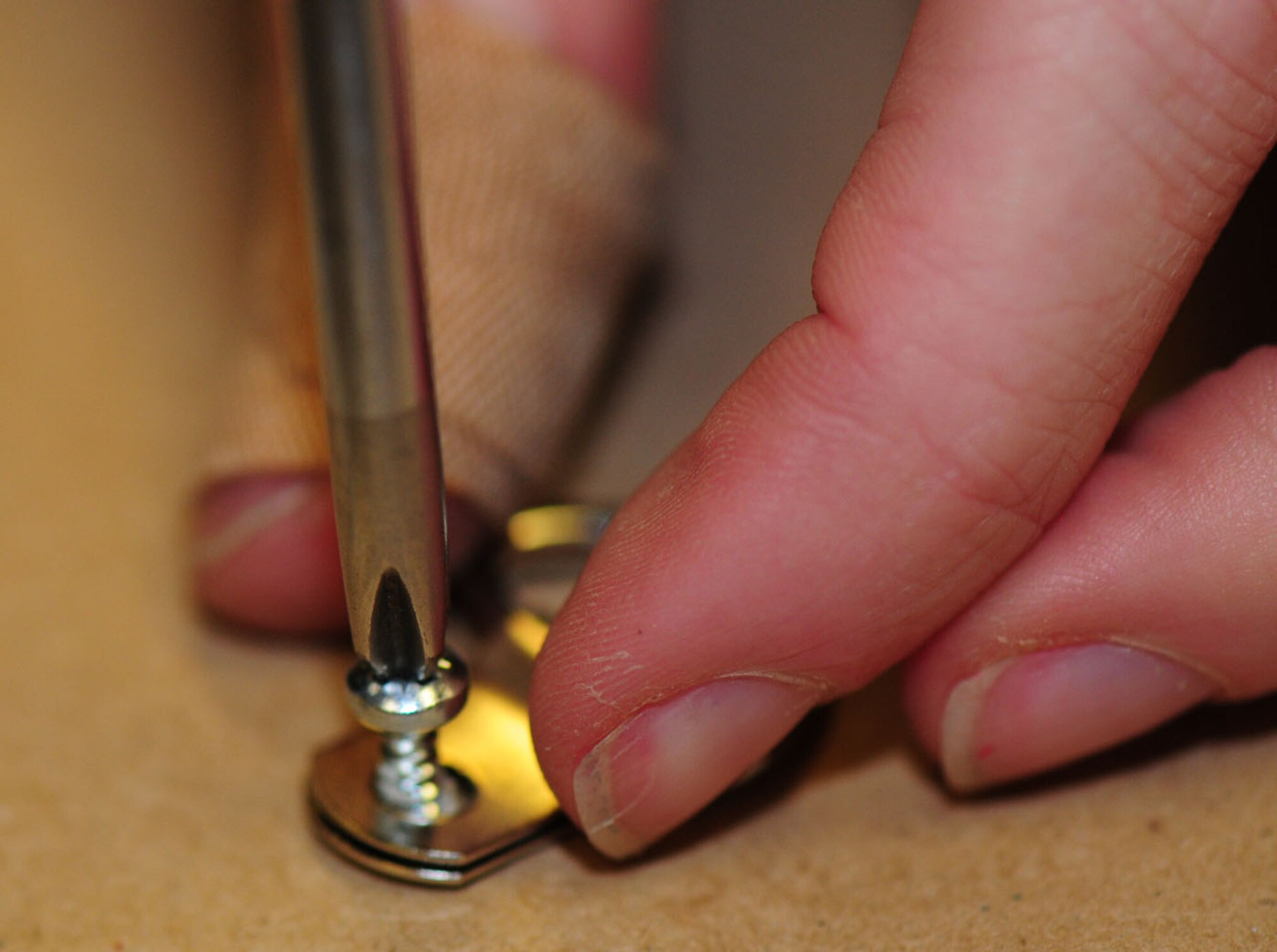 RAF MILDENHALL, England – Megan Wellentin, 100th Force Support Squadron Arts and Crafts Complex framer, screws a hanger into position on the back of a custom-made frame, before attaching a mounting wire May 4, 2012.  The complex offers a framing service for customers and can frame personal items such as photos and going-away gifts such as squadron guidons, patches and coins.  (U.S. Air Force photo/Karen Abeyasekere)
 
