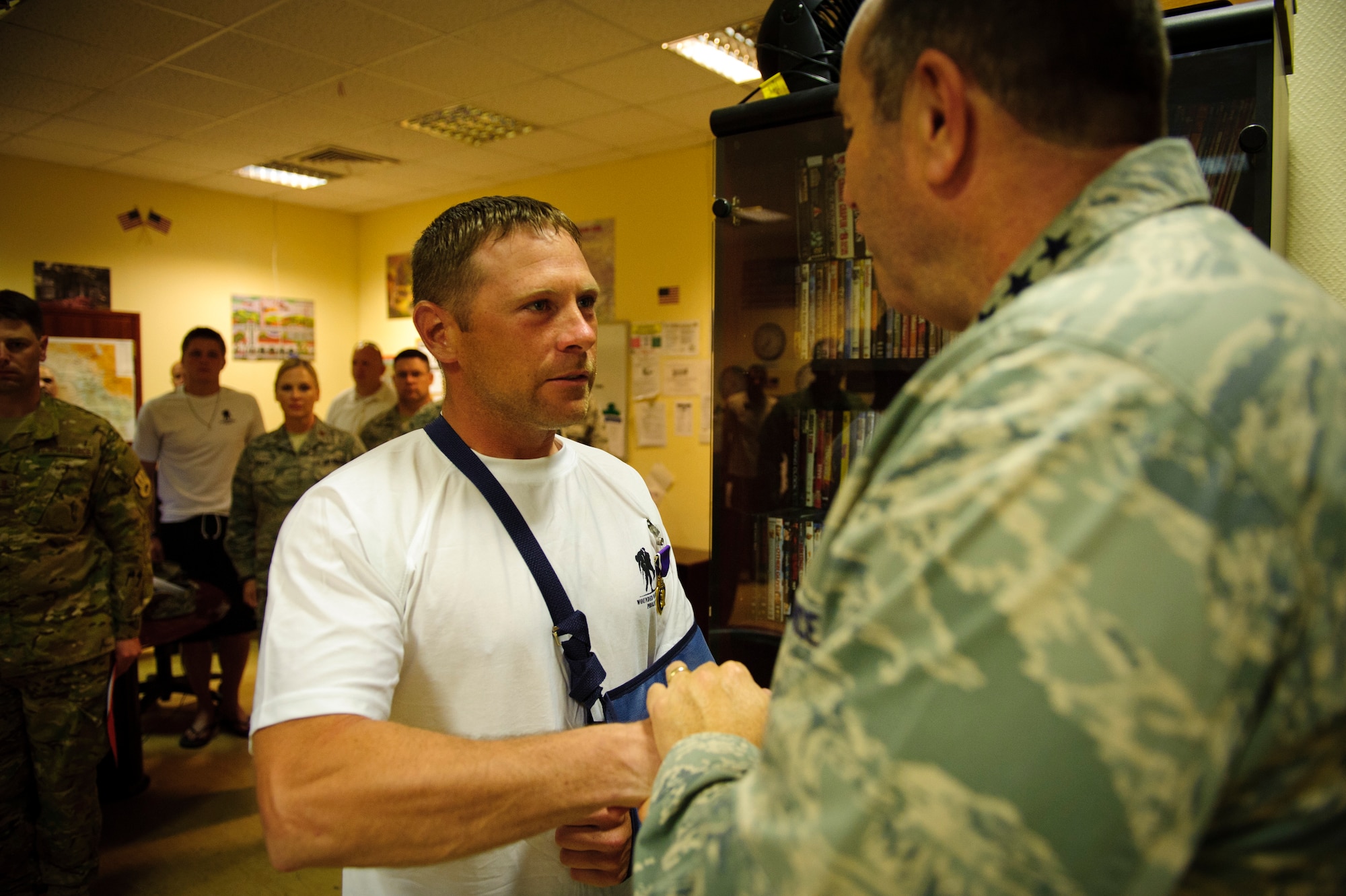 Air Force Vice Chief of Staff Gen. Phil Breedlove talks with Tech. Sgt. Jake Tieman after presenting him the Purple Heart at a base in Southwest Asia May 7, 2012.  Tieman is a member of the 577th Expeditionary Civil Engineer Squadron's Base Engineer Emergency Force, also known as "Prime BEEF."  He was wounded by shrapnel near a forward operating base in Afghanistan. 