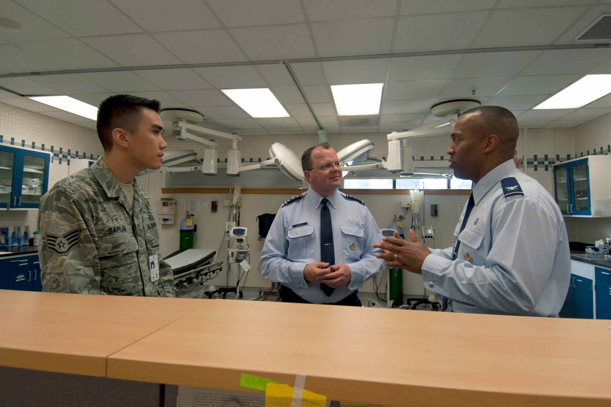 Lt. Gen. Bruce Green, center, Air Force surgeon general, and Staff Sgt. Jonathan Saplan, left, 8th Medical Group ambulance service technician, listen to Col. Alvis Headen, 8th MDG commander, talk about the unique capabilities of the emergency clinic on Kunsan Air Base, Republic of Korea, May 9, 2012.  While the 8th MDG does not have an emergency room, Airmen can visit the after-hours clinic to receive care. (U.S. Air Force photo/Senior Airman Jessica Hines)   