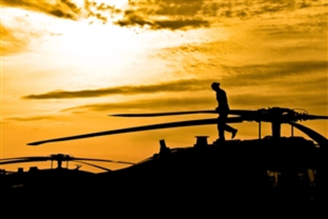 U.S. Army Chief Warrant Officer 2 Norma Garza conducts a pre-flight inspection on a UH-60 Black Hawk helicopter as the sun rises in on Camp Marmal, Afghanistan, May 2, 2012. Garza is a pilot assigned to 1st Cavalry Division's Company A, 1st Air Cavalry Brigade.