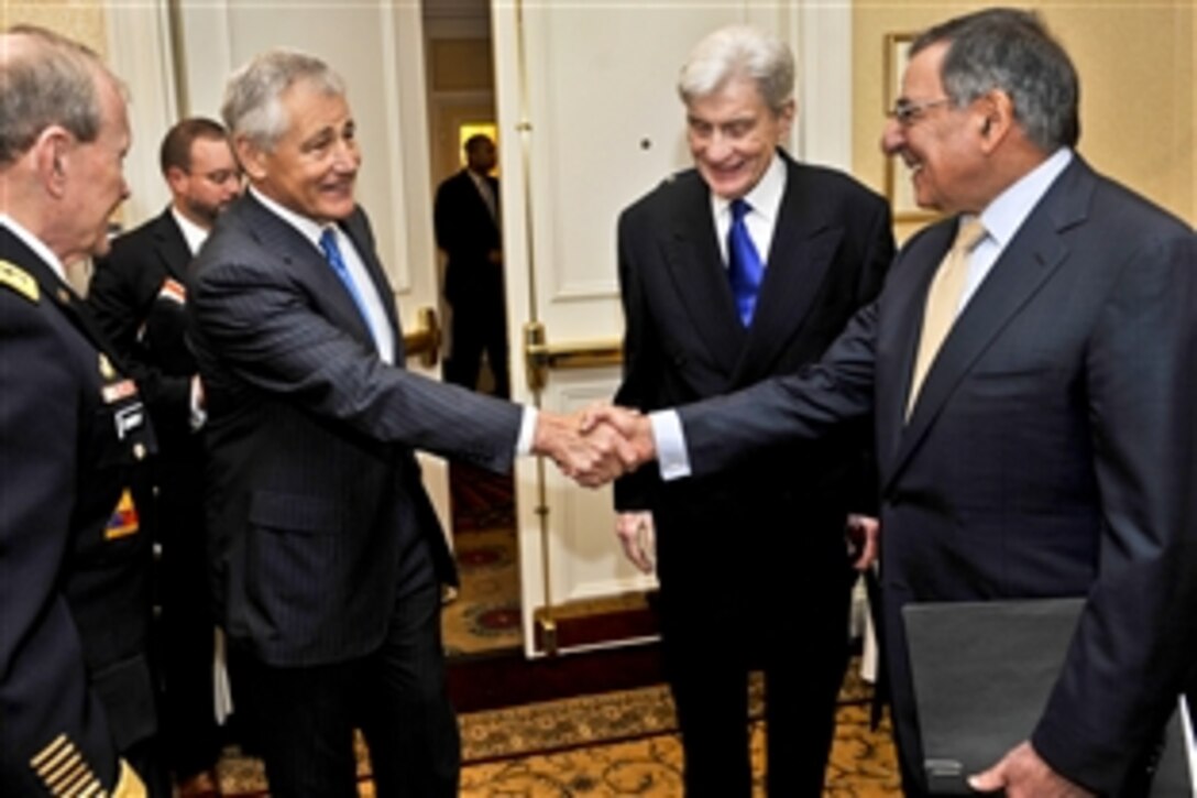 Former U.S. Sen. Chuck Hagel of Nebraska shakes hands with Defense Secretary Leon E. Panetta shortly before Panetta and Army Gen. Martin E. Dempsey, chairman of the Joint Chiefs of Staff, deliver remarks as the keynote speakers at a forum on the Law of the Sea Convention in Washington, D.C., May 9, 2012.