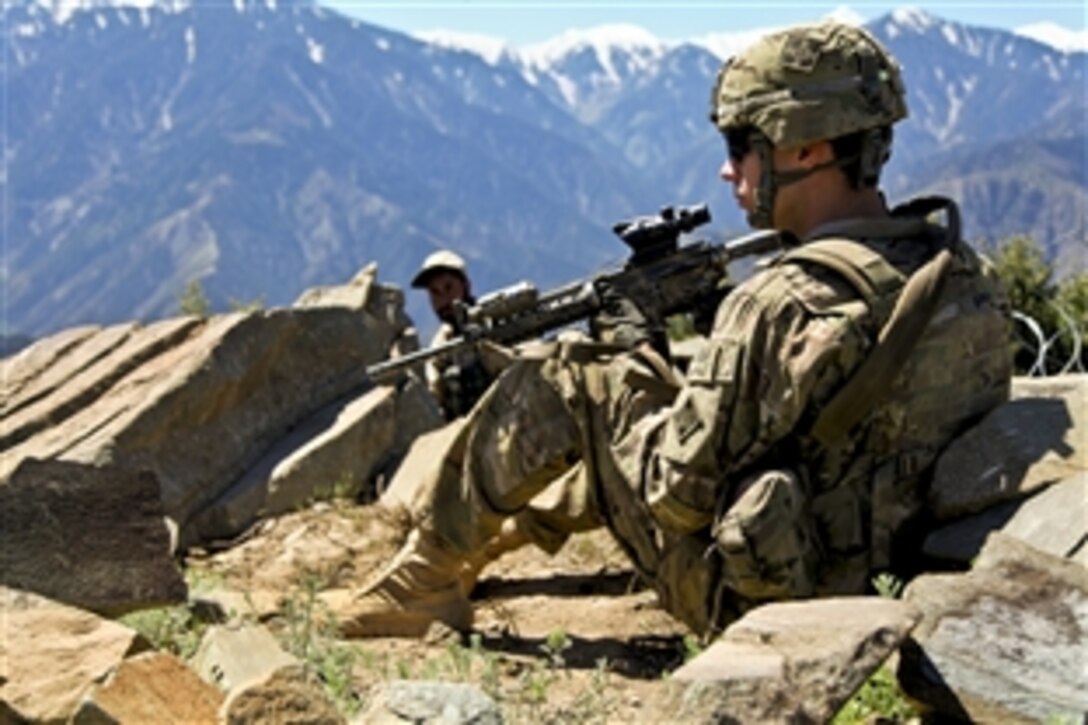 U.S. Army Pfc. Jeffery Penning and an Afghan security guard pull security during a roving patrol on Observation Post Mustang in Afghanistan's Kunar province, May 3, 2012. Penning is assigned to the 4th Infantry Division's Company C, 1st Battalion, 12th Infantry Regiment.