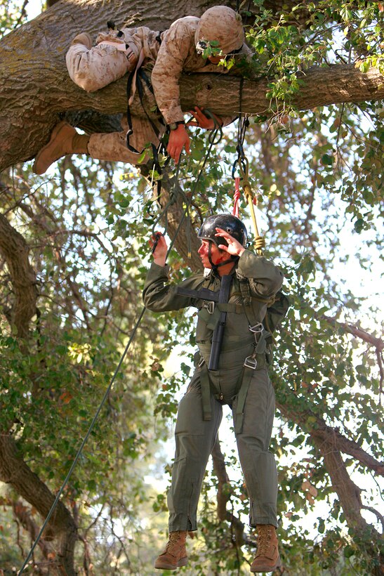 Sergeant Scott W. Ghilcrist, recovery team leader, Tactical Recovery of Aircraft and Personnel Platoon, 15th Marine Expeditionary Unit, prepares to rescue Cpl. Brittany L. Jones, who was playing the role of a downed pilot during training, here, May 9. The training was conducted as a part of the ground portion of Realistic Urban Training, an exercise designed to prepare the 15th MEU for their upcoming deployment scheduled for this fall. Ghilcrist, 24, is from Hurst, Texas, and Jones, 25, is a radio operator with the unit and hails from Elizabethtown, N.C.
