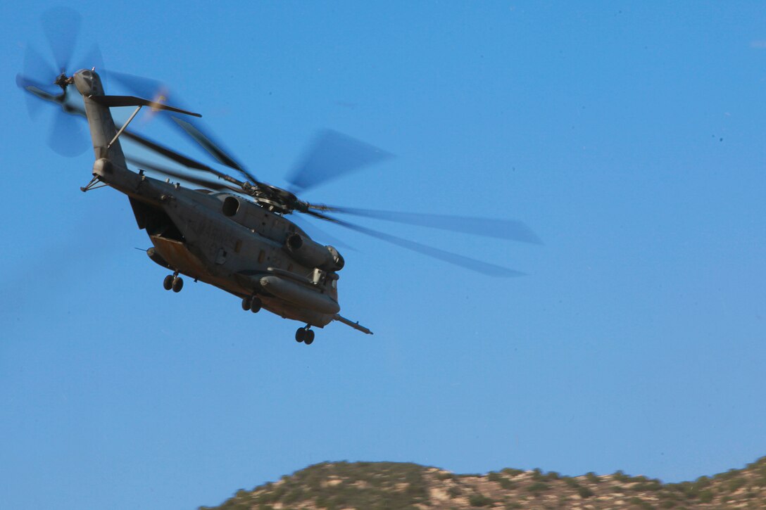 A CH-53E Super Stallion carrying the Tactical Recovery of Aircraft and Personnel Platoon, 15th Marine Expeditionary Unit, leaves after successfully completing a simulated rescue of personnel, May 9. The training was conducted as a part of the ground portion of Realistic Urban Training, an exercise designed to prepare the 15th MEU for their upcoming deployment scheduled for this fall.