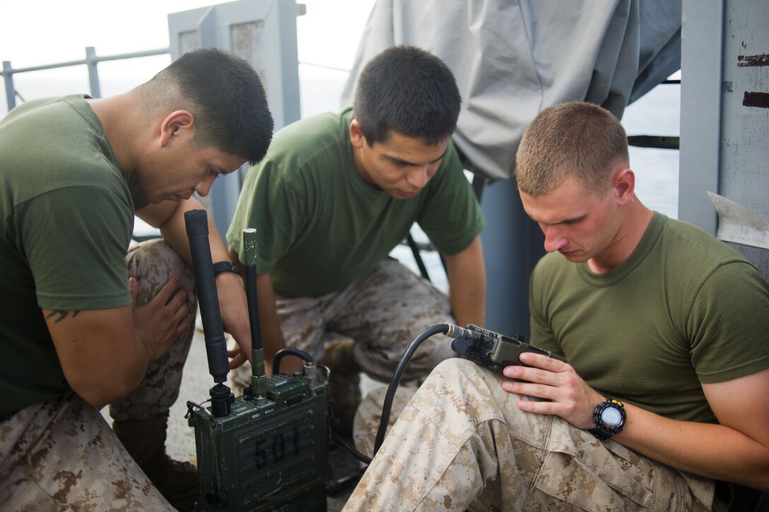 Marines with the 11th Marine Expeditionary Unit program a radio during a class aboard USS Pearl Harbor here May 9. The unit embarked the ship, as well as USS Makin Island and USS New Orleans in San Diego Nov. 14, beginning a seven-month deployment to the Western Pacific, Horn of Africa and Middle East regions.