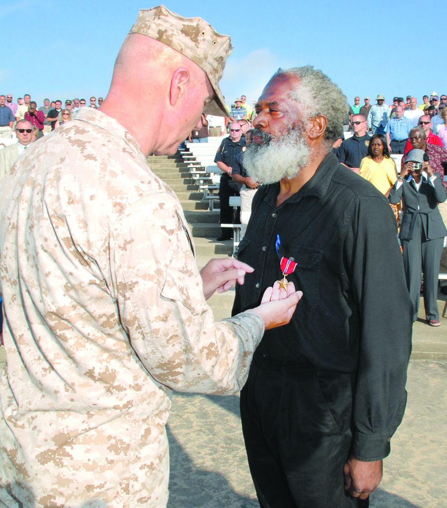 Maj. Gen. Charles Hudson, commanding general, Marine Corps Logistics Command, presents the Bronze Star with Combat “V” for valor, May 1, to Willie J. Robinson for heroic actions while deployed south of DaNang, Vietnam, in 1965.