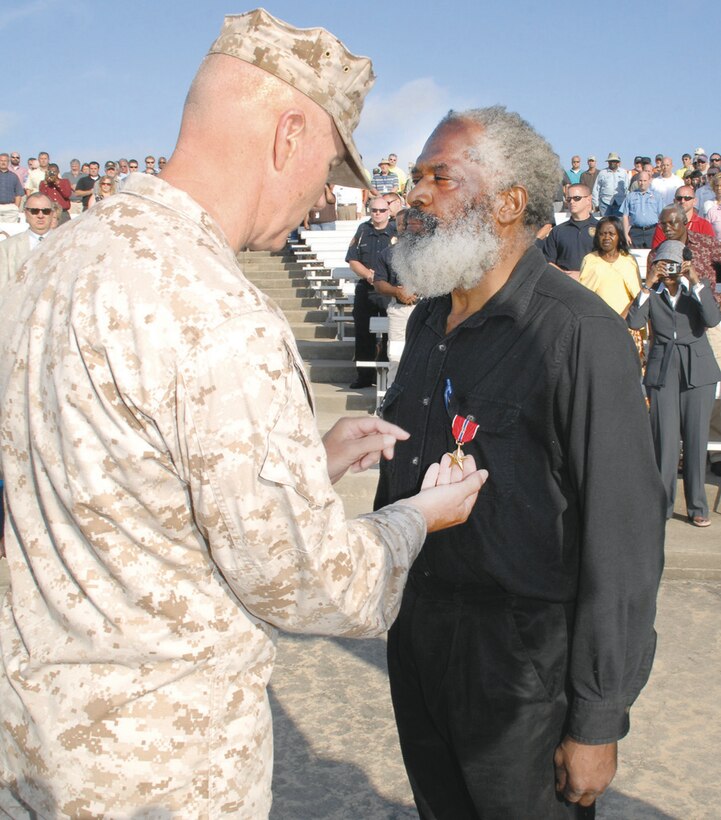 Maj. Gen. Charles Hudson, commanding general, Marine Corps Logistics Command, presents the Bronze Star with Combat “V” for valor, May 1, to Willie J. Robinson for heroic actions while deployed south of DaNang, Vietnam, in 1965.