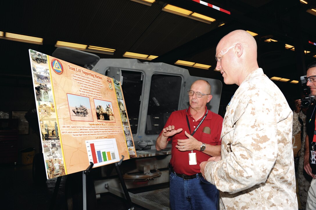During his visit here, Sgt. Maj. Micheal P. Barrett learns about the Marine Corps’ light armored vehicles’ maintenance conducted at Production Plant Albany.
