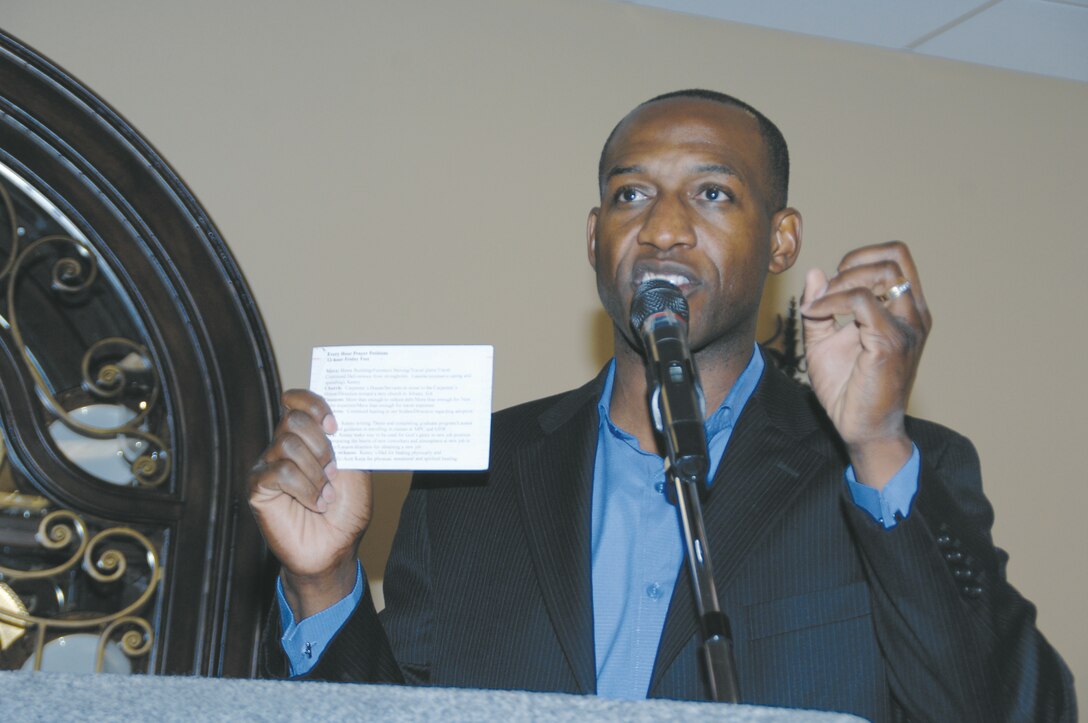 Retired Marine Capt. Ken Bevel, now an associate minister at Sherwood Baptist Church, Albany, Ga., holds up his prayer card and tells the nearly 70 base personnel in attendance that they cannot live without prayer during the National Day of Prayer observance held at the Town and Country Restaurant’s Grand Ballroom,?May 3.