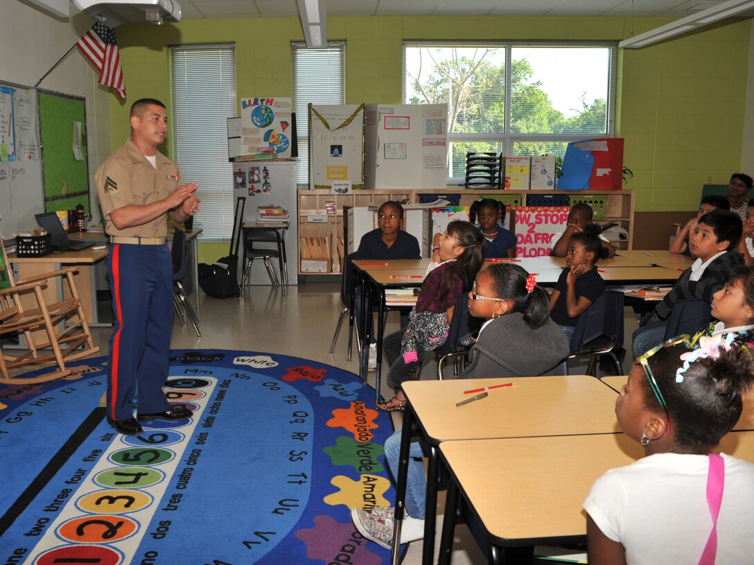 Cpl. Rolando Noriega, a correspondence clerk with Headquarters, 8th Marine Corps District, speaks with fourth-graders about what it takes to be a United States Marine, May 10, 2012, at John T. White Elementary School, in Fort Worth, Texas. The campus, now in its first school year, hosted their first career day where children learned about the opportunities that await them upon graduating from high school. Noriega said the Marines’ presence at career days provides positive role models and gives children a glimpse into life as a Marine.