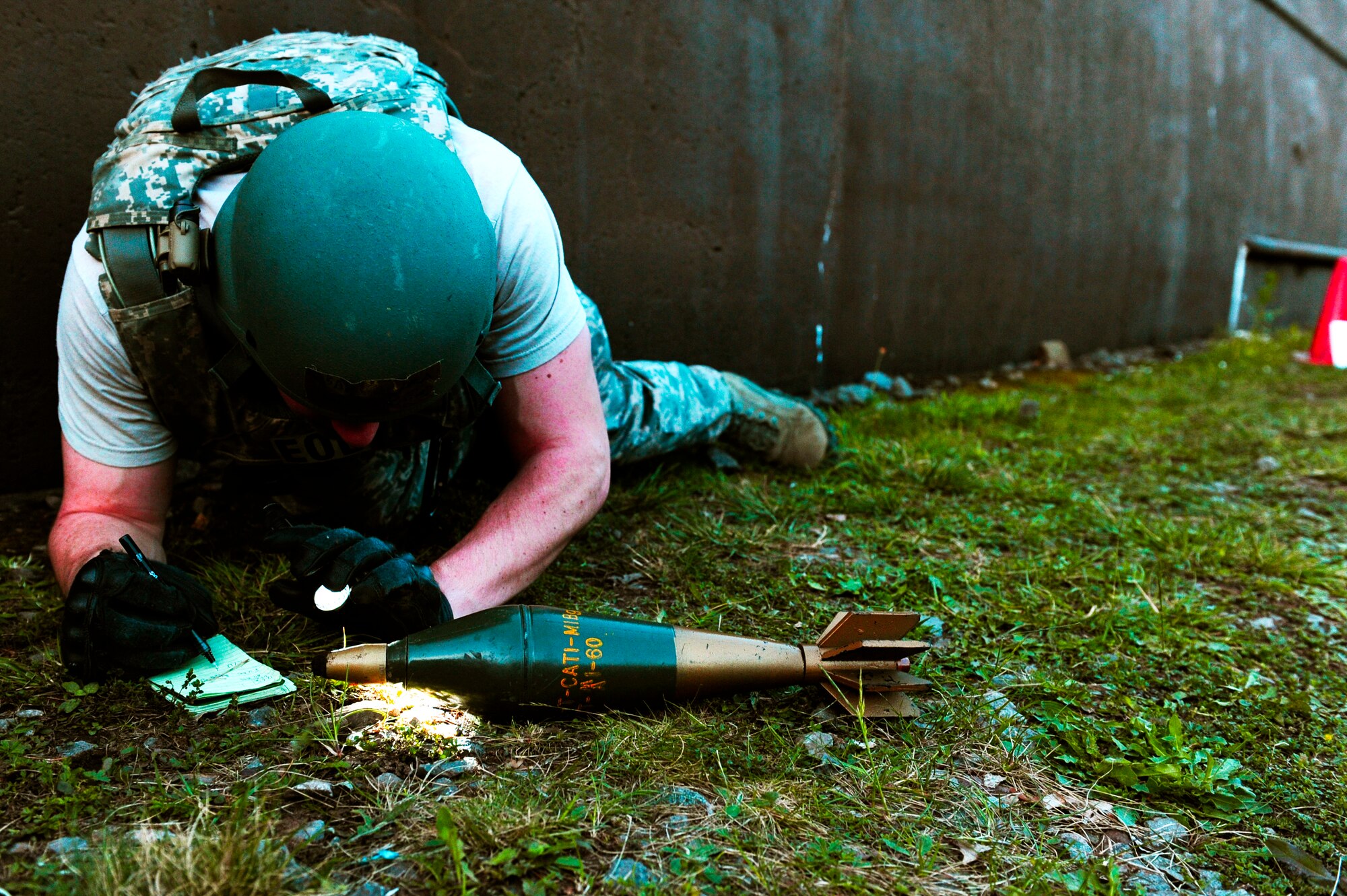 Senior Airman Jeff Gilmer, 886th Civil engineer Squadron, explosive ordinance disposal technician, performs standard procedures on a simulated unexploded ordinance during an operational readiness exercise scenario on Ramstein Air Base, Germany, May 10, 2012. The ORE incorporates a series of scenarios used to evaluate a base's readiness to execute operational duties while responding to various crises. (U.S. Air Force photo/Senior Airman Aaron-Forrest Wainwright)