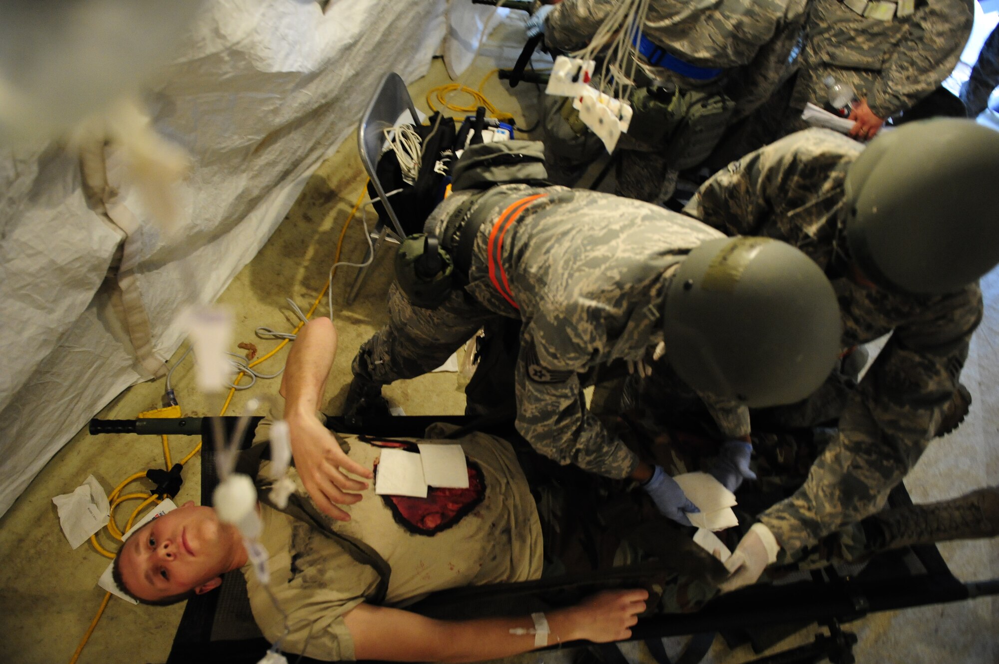 Ramstein Medical personnel perform medical care to a simulated victim during an operational readiness exercise on Ramstein Air Base, Germany, May 10, 2012. The ORE incorporates a series of scenarios that are used to evaluate a base's readiness to execute operational duties while responding to various crises. (U.S. Air Force photo/Senior Airman Aaron-Forrest Wainwright)
