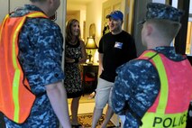Master Sgt. Tony Karpenko, 647th Logistics Readiness Squadron Fuels flight, and his wife Michele, speak to Petty Officer 2nd Class Tim Moss and Seaman Scott Meyer, Pearl Harbor harbor patrolmen, during Operation ENLIGHTEN II, May 9, where Airmen and Sailors went to more than 2,000 homes to hand out information about safety and security. In response to a rash of crimes ranging from petty theft to grand larceny, Joint Base Pearl Harbor-Hickam officials engaged residents in the anti-crime campaign. More than 120 volunteers went door-to-door during the blitz event. (U.S. Air Force photo/Staff Sgt. Mike Meares)