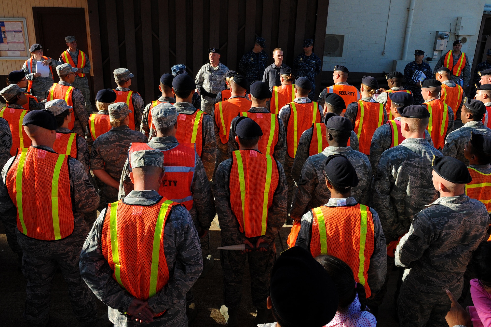 Lt. Col. Michael Gimbrone, 647th Security Forces Squadron commander, speaks to more than 120 volunteers at the beginning of Operation ENLIGHTEN II, May 9, where Airmen and Sailors went to more than 2,000 homes to hand out information about safety and security. In response to a rash of crimes ranging from petty theft to grand larceny, Joint Base Pearl Harbor-Hickam officials engaged residents in the anti-crime campaign. (U.S. Air Force photo/Staff Sgt. Mike Meares)