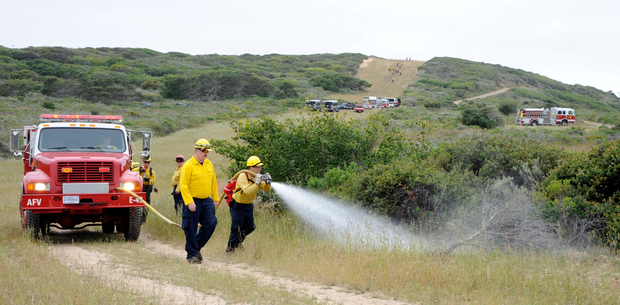 VANDENBERG AIR FORCE BASE, Calif. -- Rich Dibuo, a 30th Civil Engineer Squadron Hot Shots instructor, teaches students an important technique on how to properly attack a fire along a road here Tuesday, May 1, 2012. This mobile attack provides a path for other firefighters to assist in extinguishing the fire. Vandenberg AFB is the only Department of Defense installation that provides wildland firefighter training.  