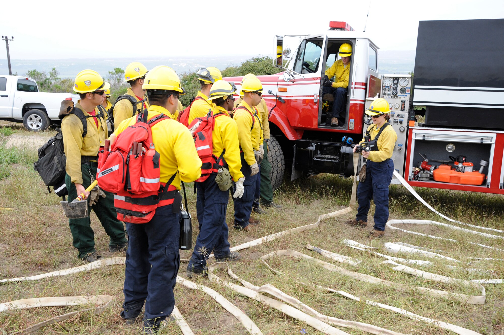 VANDENBERG AIR FORCE BASE, Calif. -- Michelle Birchfield, a 30th Civil Engineer Squadron Hot Shots instructor, provides training on fire hose maintenance to a group of students and new Airmen Tuesday, May 1, 2012. Vandenberg AFB is the only Department of Defense installation that provides wildland firefighter training. (U.S. Air Force photo/Tech. Sgt. Scottie T. McCord)  