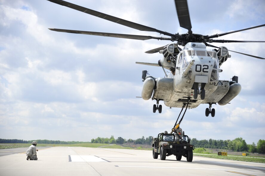 A U.S. Marine Corps CH-53E Super Stallion from Marine Heavy Helicopter Squadron 772 conducts slingload operations with Airmen from the 621st Contingency Response Wing at Joint Base McGuire-Dix-Lakehurst, N.J., May 10, 2012. Both units were preparing for the Marine airpower demonstration at the 2012 JB MDL Open House and Air Show, scheduled for May 12 and 13, 2012. (U.S. Air Force photo/Tech. Sgt. Parker Gyokeres)