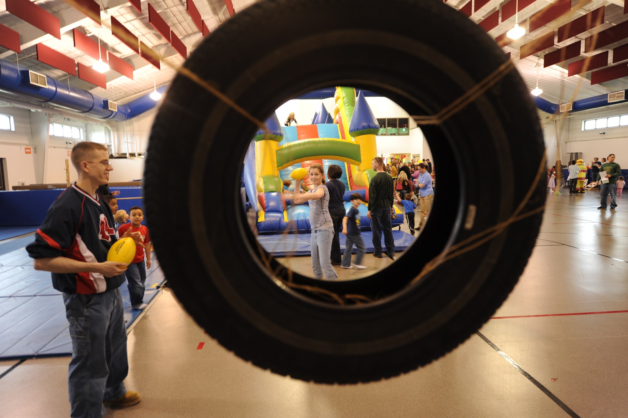Cassidy Baugh, 13, gets ready to throw a football through a hanging tire during the School Carnival in Liberty Square on May 8, 2012, on Grand Forks Air Force Base, N.D. (U.S. Air Force photo/Tim Flack)