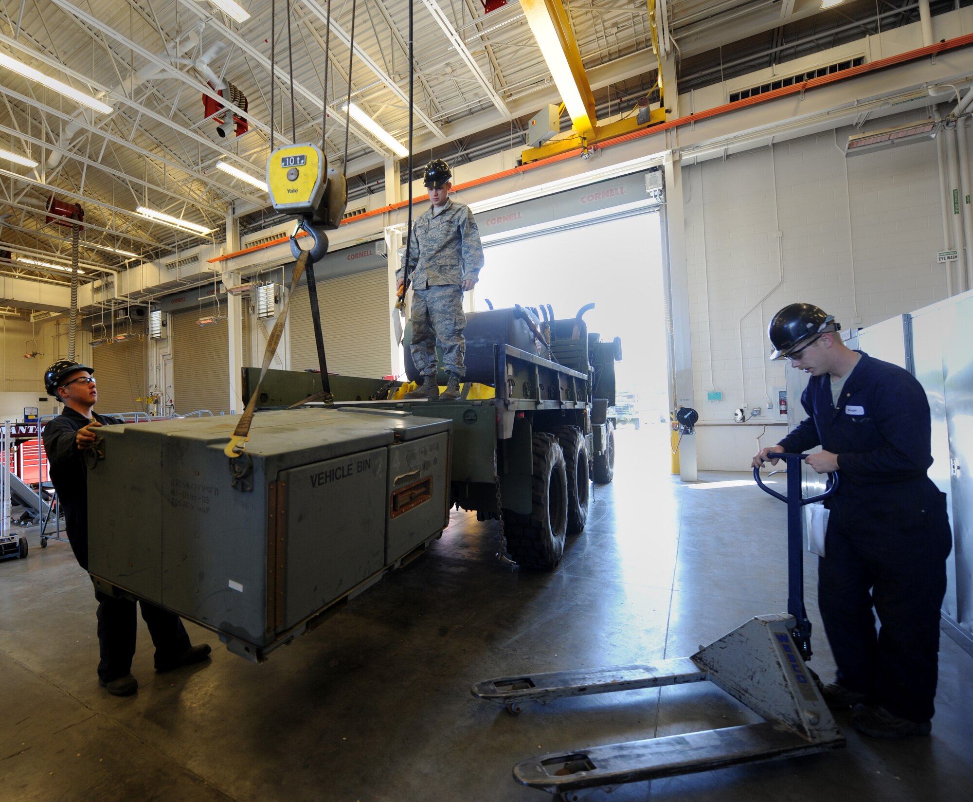 U.S. Air Force Staff Sgt. Jeff Wright, 726th Air Control Squadron vehicle maintenance supervisor, operates an overhead crane while Airman 1st Class Jordan Arndt, 726th ACS vehicle maintainer, ensures its stability during an exercise at Mountain Home Air Force Base, Idaho, May 10, 2012. The exercise tested the unit’s ability to load equipment and perform a vehicle convoy as they would in a deployed location. (U.S. Air Force photo/Staff Sgt. Gina Paige)