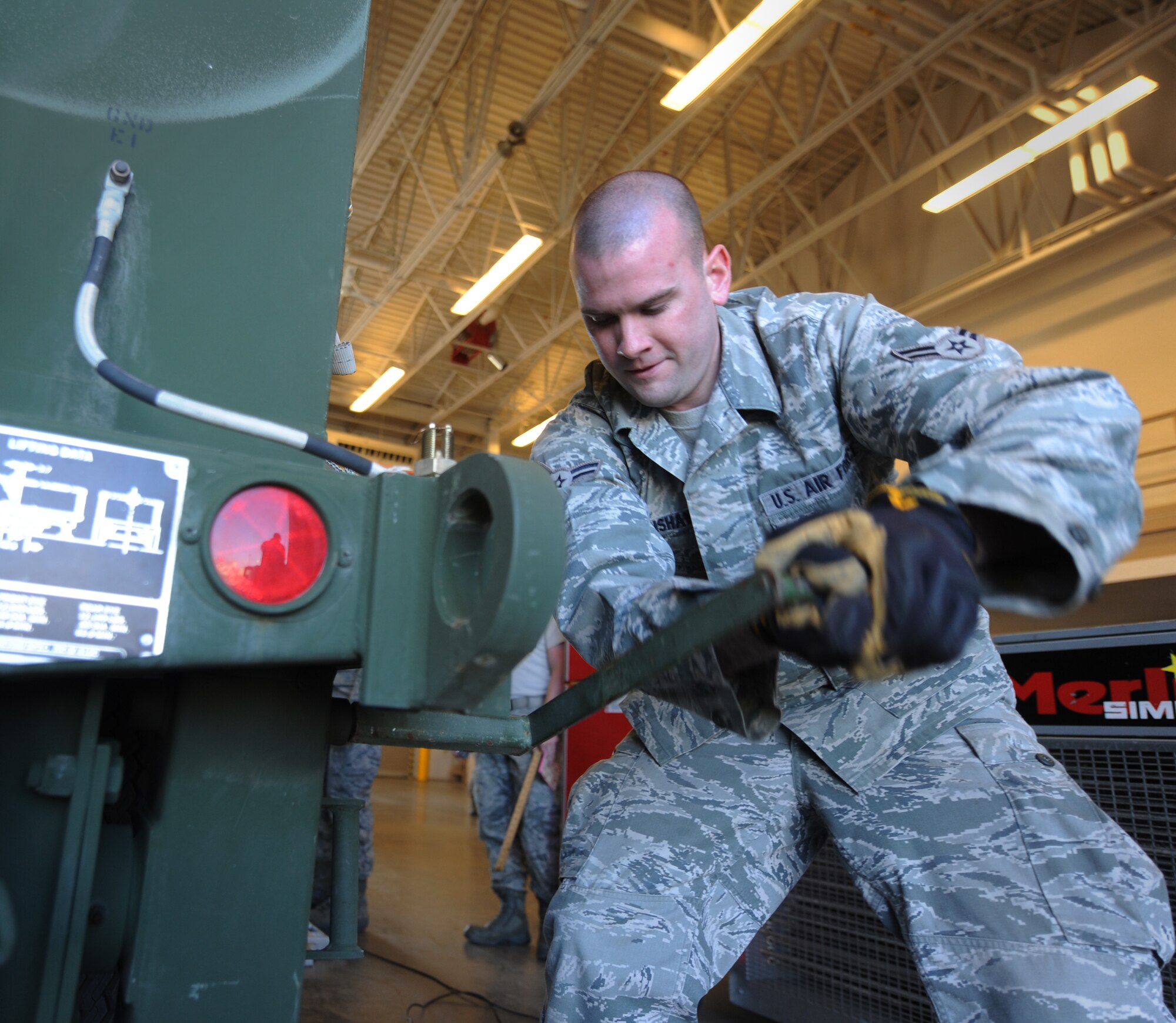 U.S. Air Force Airman 1st Class Zach Hinshaw, 726th Air Control Squadron aerospace ground equipment, levels a Tactical Quiet Generator on a scale during an exercise at Mountain Home Air Force Base, Idaho, May 10, 2012. The generator, which averages 14,390 pounds, must be weighed to ensure proper loading onto an aircraft. (U.S. Air Force photo/Staff Sgt. Gina Paige)