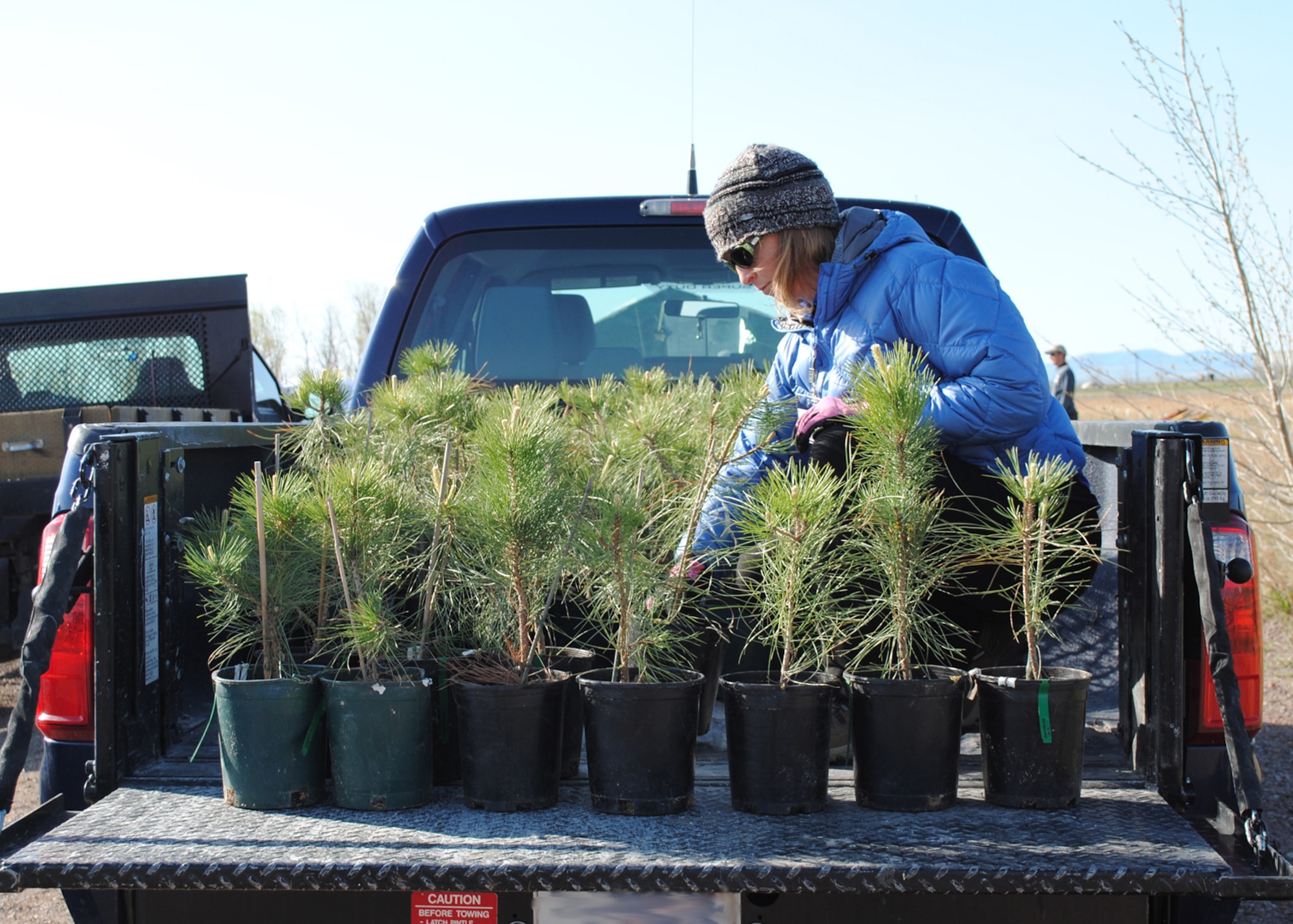 Wendy Roehm, parent volunteer, organizes Cottonwood and Ponderosa trees at Powwow Pond May 5. More than 34 Great Falls High School students and volunteers from the Cascade County Conservation District, U.S. Forest Service, Great Falls Park and Recreation Department and the 341st Civil Engineer Squadron planted 320 trees at Powwow Park in celebration of Arbor Day. (U.S. Air Force photo/Airman 1st Class Katrina Heikkinen)