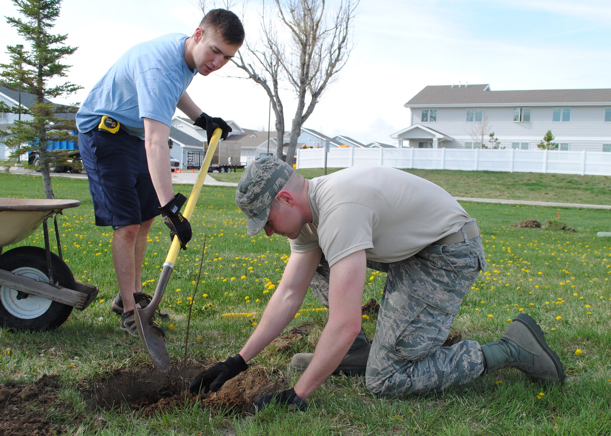 Airman Rory Stodgell, 341st Logistics Readiness Squadron traffic management apprentice, left, and Airman 1st Class Tyler Johnson, 341st LRS traffic management cargo apprentice, plant a Japanese lilac tree at Sun Plaza Park April 25. (U.S. Air Force photo/Airman 1st Class Katrina Heikkinen)