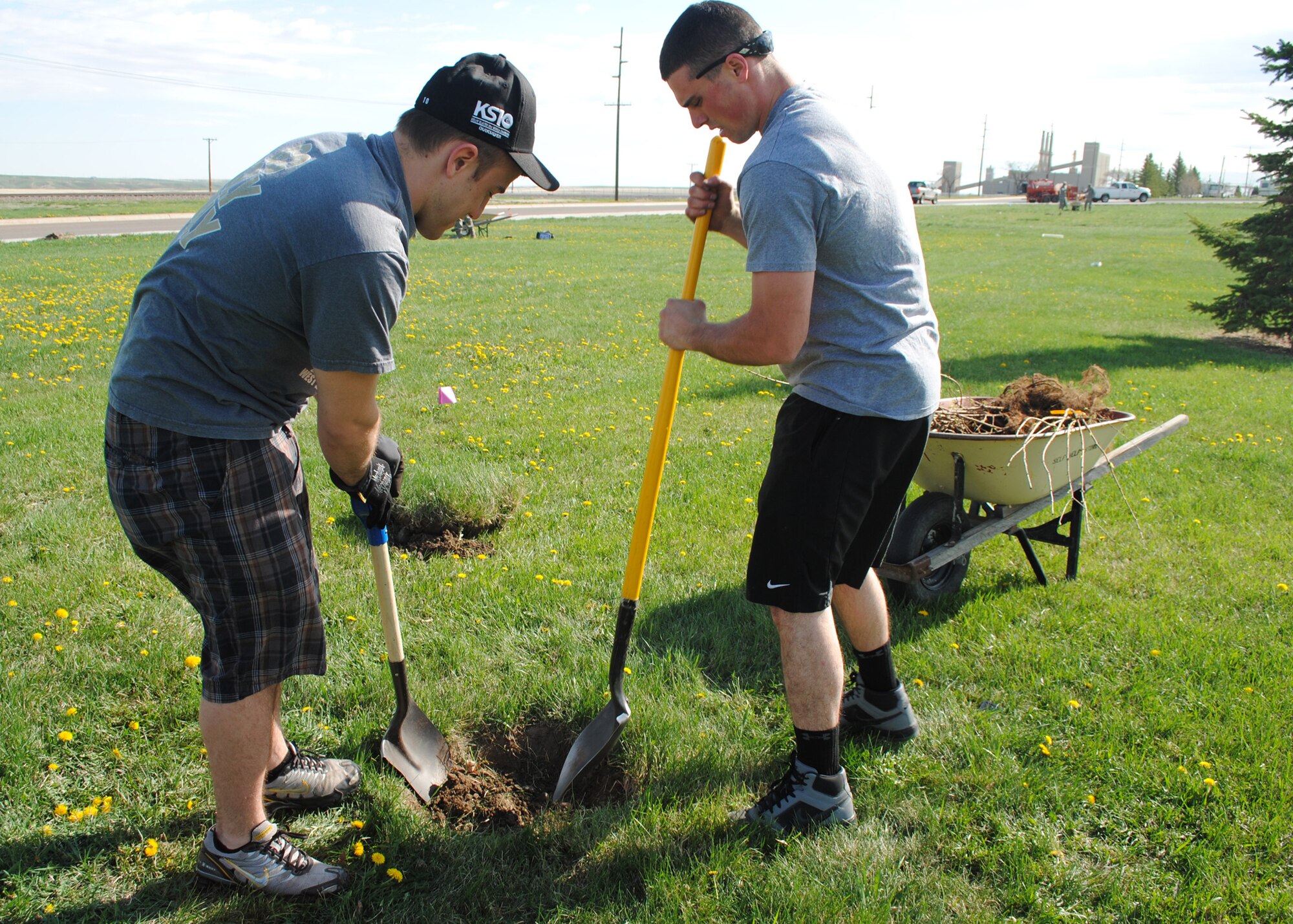Airman 1st Class Michael Brinkofski, 341st Logistics Readiness Squadron vehicle and equipment apprentice, left, and Airman 1st Class Aaron Pace, 341st LRS vehicle equipment mechanic, dig a hole for a Red maple tree at Sun Plaza Park April 25. More than 20 Airmen volunteered to plant 110 trees at the park in celebration of Earth Day. (U.S. Air Force photo/Airman 1st Class Katrina Heikkinen)