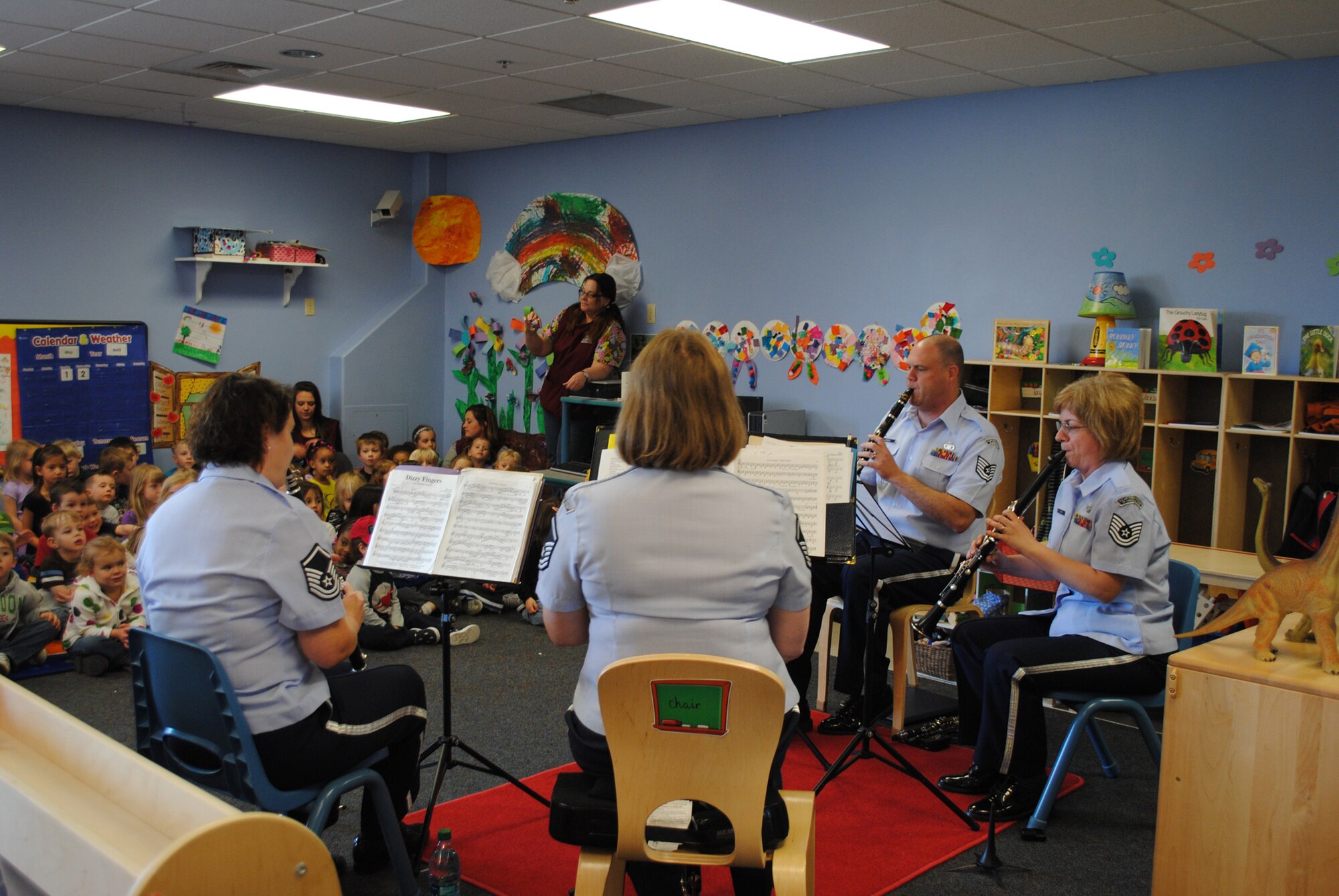 Left to right, Master Sgt. Shelly Steepe, Master Sgt. Allison Baugh, Tech Sgt. Amy Lynch, and Tech. Sgt. Richard LaCroix, all U.S. Air Force Heartland of America Band members, play "Dizzy Fingers" on their clarinets for children at the Child Development Center May 2. (U.S. Army photo/Airman 1st Class Katrina Heikkinen)