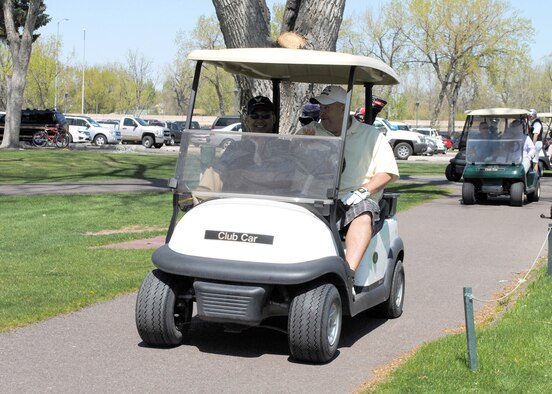 Col. H.B. Brual, 341st Missile Wing commander, and Rick Naccarato, 341st Civil Engineer Squadron assistant chief of fire prevention, drive a golf cart at Meadow Lark Country Club during the 37th annual Great Falls Area Chamber of Commerce Military Affairs Committee Golferoo May 7. The Golferoo was an opportunity for members of Team Malmstrom to golf at Meadow Lark without a membership and interact with MAC members and the people of the Great Falls community. (U.S. Air Force photo/Airman 1st Class Katrina Heikkinen) 
