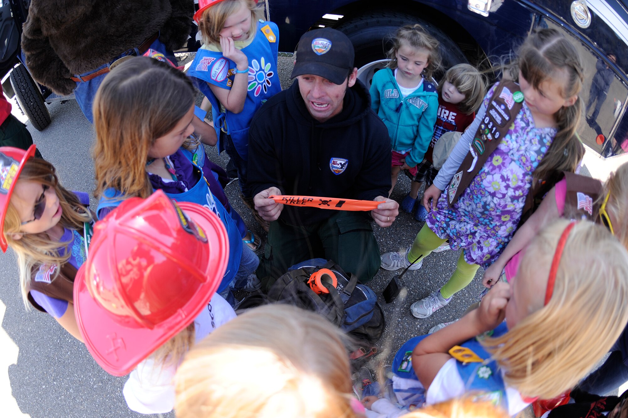 VANDENBERG AIR FORCE BASE, Calif. -- Nathan Ogan, a 30th Civil Engineer Squadron firefighter, shows a tool to Space and Sea Girl Scouts during a fire safety class at the parade grounds here Wednesday, May 9, 2012. The Vandenberg Hot Shots explained their role in fighting wilderness fires and showed the tools they use to fight fire. (U.S. Air Force photo/Staff Sgt. Andrew Satran) 

 