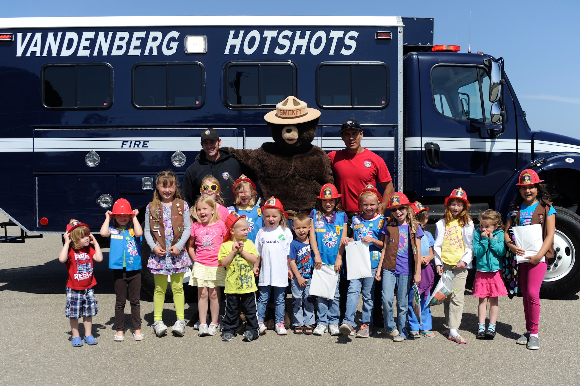VANDENBERG AIR FORCE BASE, Calif. -- Space and Sea Girl Scouts pose for a photo with Vandenberg Hot Shots during a safety awareness class at the parade grounds here Wednesday, May 9, 2012. The Vandenberg Hot Shots explained their role in fighting wilderness fires and showed the tools they use to fight fire. (U.S. Air Force photo/Staff Sgt. Andrew Satran) 

 