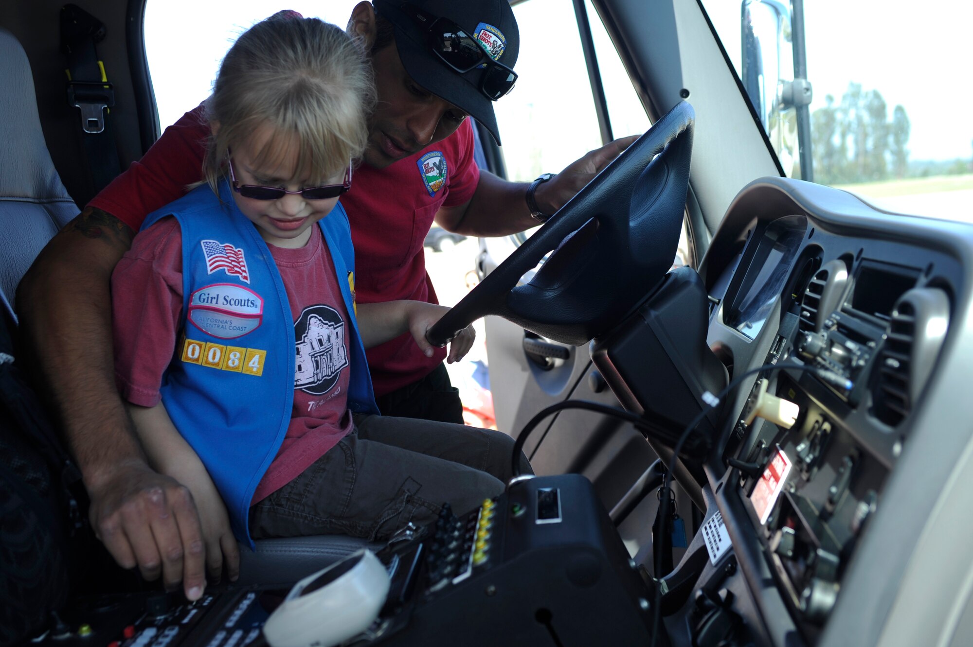 VANDENBERG AIR FORCE BASE, Calif. -- Joel Rodriguez, a 30th Civil Engineer Squadron fire fighter, shows Katelyn Lowder, a Space and Sea Girl Scout, the mechanics of the Vandenberg Hot Shot truck during a safety awareness class at the parade grounds here Wednesday, May 9, 2012. The Vandenberg Hot Shots explained their role in fighting wilderness fires and showed the tools they use to fight fire. (U.S. Air Force photo/Staff Sgt. Andrew Satran) 

 