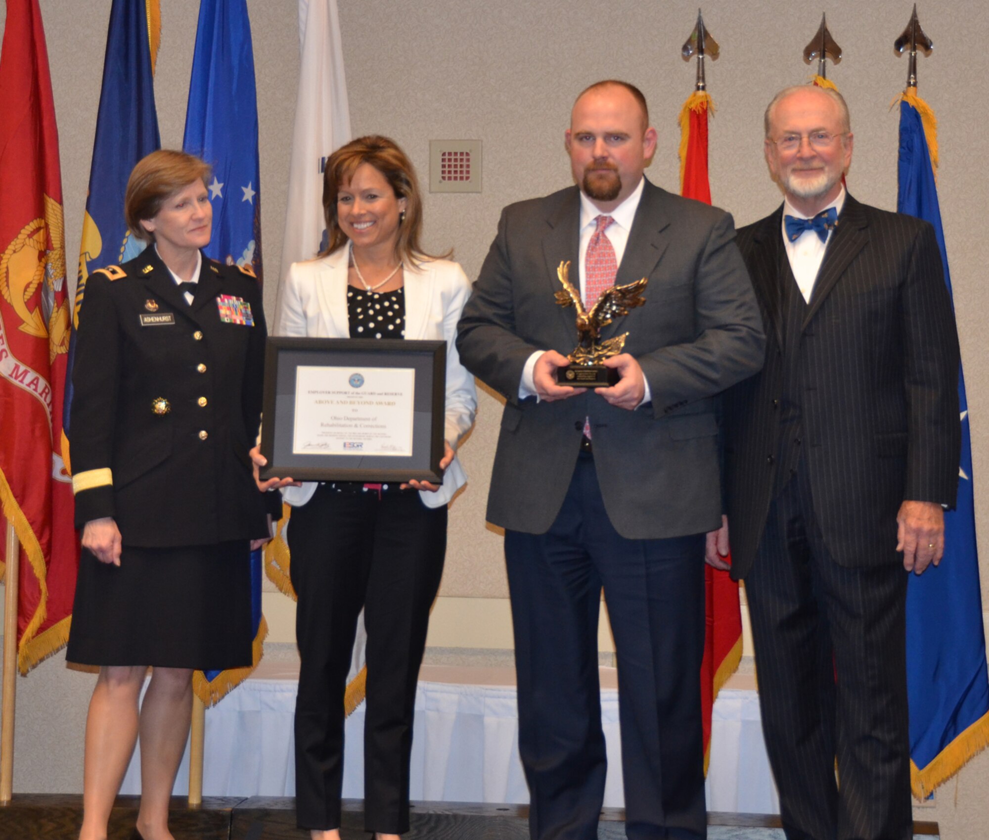 WRIGHT-PATTERSON AIR FORCE BASE, Ohio – Maj. Gen. Deborah Ashenhurst, the Ohio Adjutant General (left), and John Hoppers, Ohio Committee for the Employers Support of  the Guard and Reserve state chairman (far right), present the Above and Beyond Award to Jason Herd and Mona Hobbs from the Ohio Department of Rehabilitation & Corrections March 31. Herd and Hobbs are employers of Tech. Sgt. David Miller, 445th Civil Engineering Squadron. The Above and Beyond Award recognizes employers at the state and local level who have gone above and beyond the legal requirements for granting leave and providing support for military duty by their employees as defined by the Uniformed Services Employment and Reemployment Rights Act. (U.S. Air Force photo/Lt. Col. Cynthia Harris)