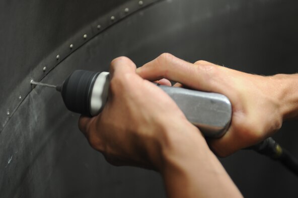 U.S. Air Force Airman 1st Class Matthew Beehler removes a rivet from an engine-augmenter duct at the sheet metals shop on Seymour Johnson Air Force Base, N.C., May 7, 2012. The duct attaches to the F-15E Strike Eagle and is a means for funneling exhaust gases through the back of the aircraft. Beehler, 4th Equipment Maintenance Squadron aircraft structural journeyman, is a native of Rose City, Mich. (U.S. Air Force photo/Airman 1st Class John Nieves Camacho/Released)