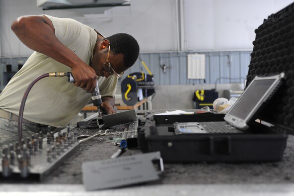U.S. Air Force Staff Sgt. Andrew Thomas drills a hole in a boarding ladder at the sheet metals shop on Seymour Johnson Air Force Base, N.C., May 7, 2012. The boarding ladder attaches to the F-15E Strike Eagle to assist aircrew with getting into the cockpit. Thomas, 4th Equipment Maintenance Squadron aircraft structural craftsman, hails from Panama City, Fla. (U.S. Air Force photo/Airman 1st Class John Nieves Camacho/Released)