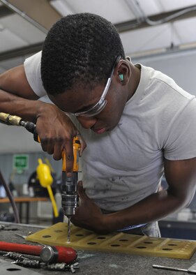 U.S. Air Force Senior Airman Vincent Wilson removes a rivet from a guard instrument at the sheet metals shop on Seymour Johnson Air Force Base, N.C., May 7, 2012. The guard instrument is used in the F-15E Strike Eagle as a cover for the control buttons in the cockpit. Wilson, 4th Equipment Maintenance Squadron aircraft structural journeyman, is from Mechanicsville, Va. (U.S. Air Force photo/Airman 1st Class John Nieves Camacho/Released)